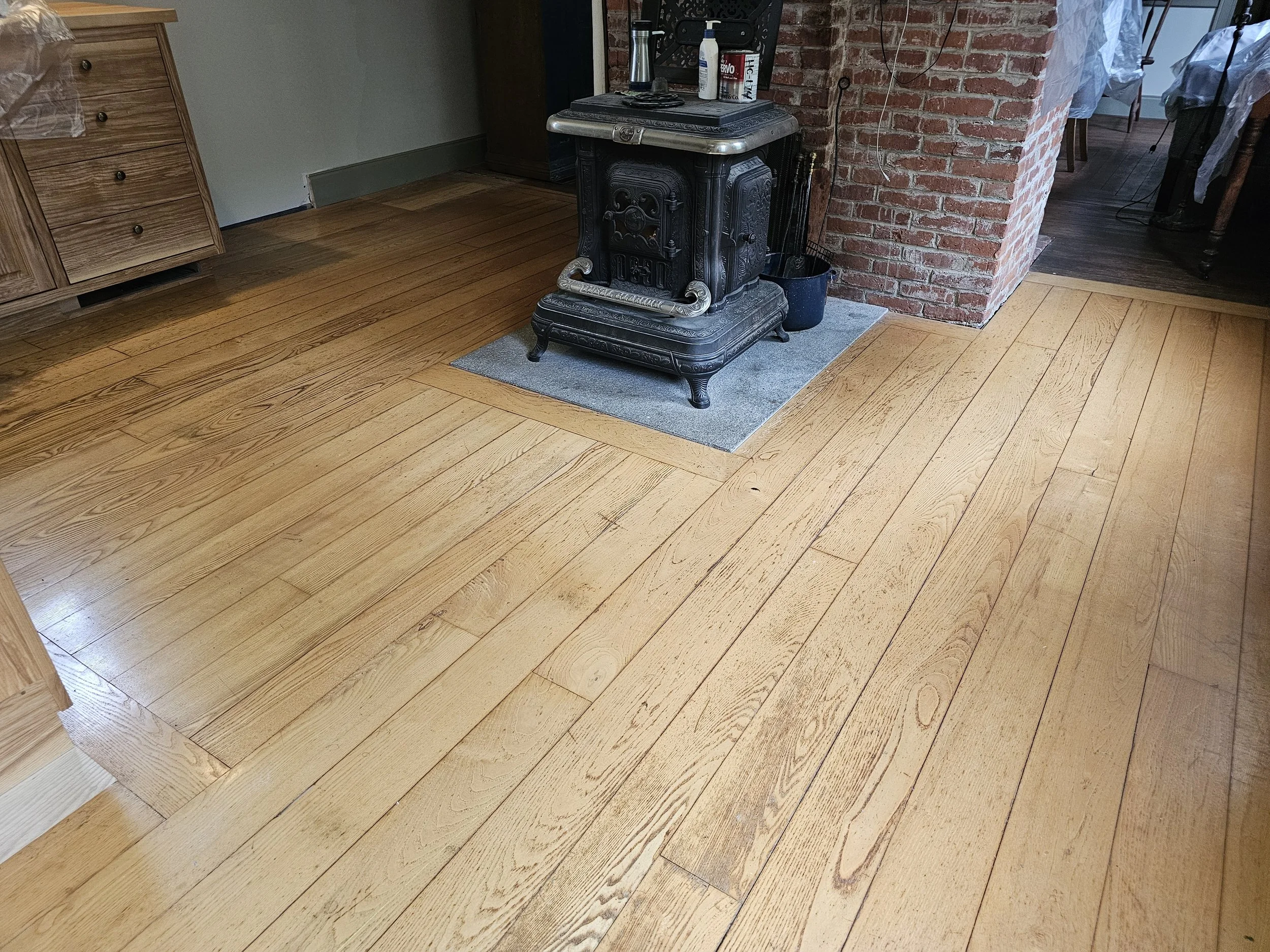Before the refinish. There was a fair amount of damage to the floor around the stove and near the kitchen cabinets. 