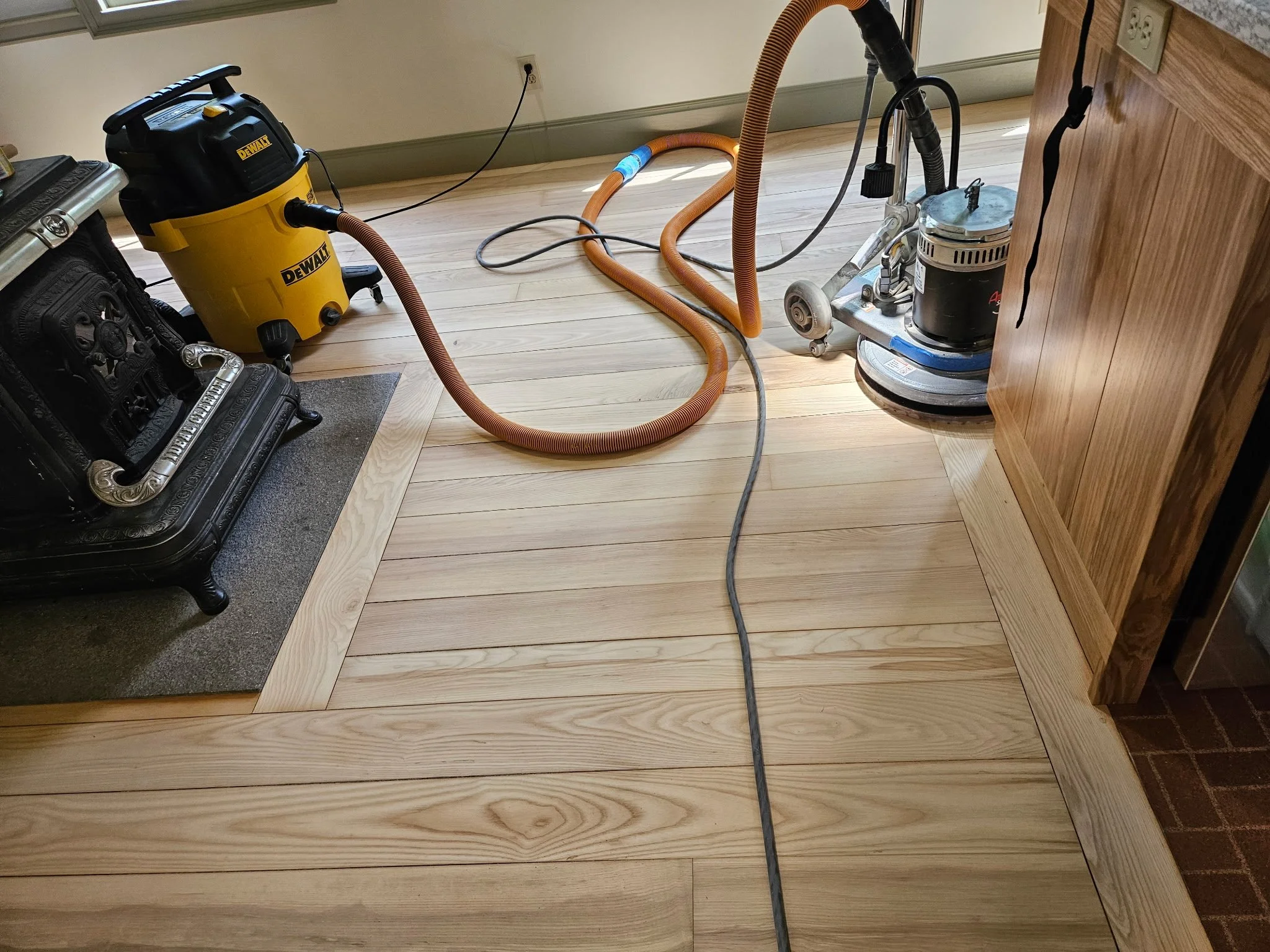 Mid sanding process. Due to the tight space, we had to utilize several specialized machines to help get into the tight spaces of this kitchen. 