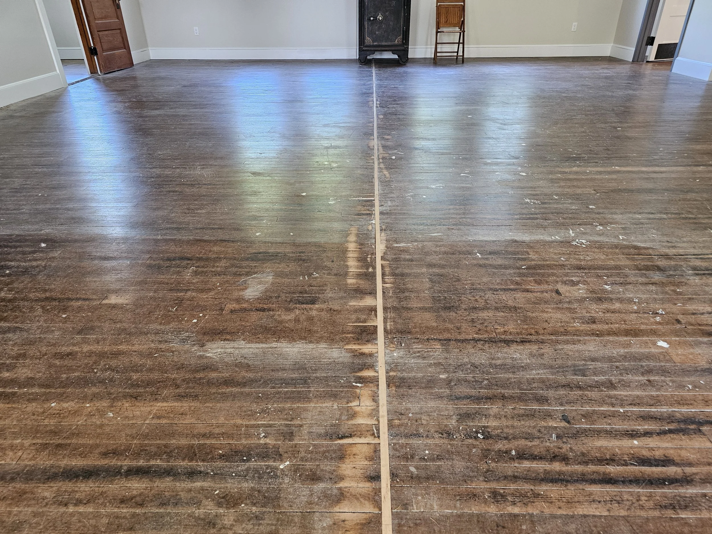 This floor features a maple strip down the middle, a unique part of it's history. When the building was moved, the floor was cut in half and rejoined by Andy after the move. 