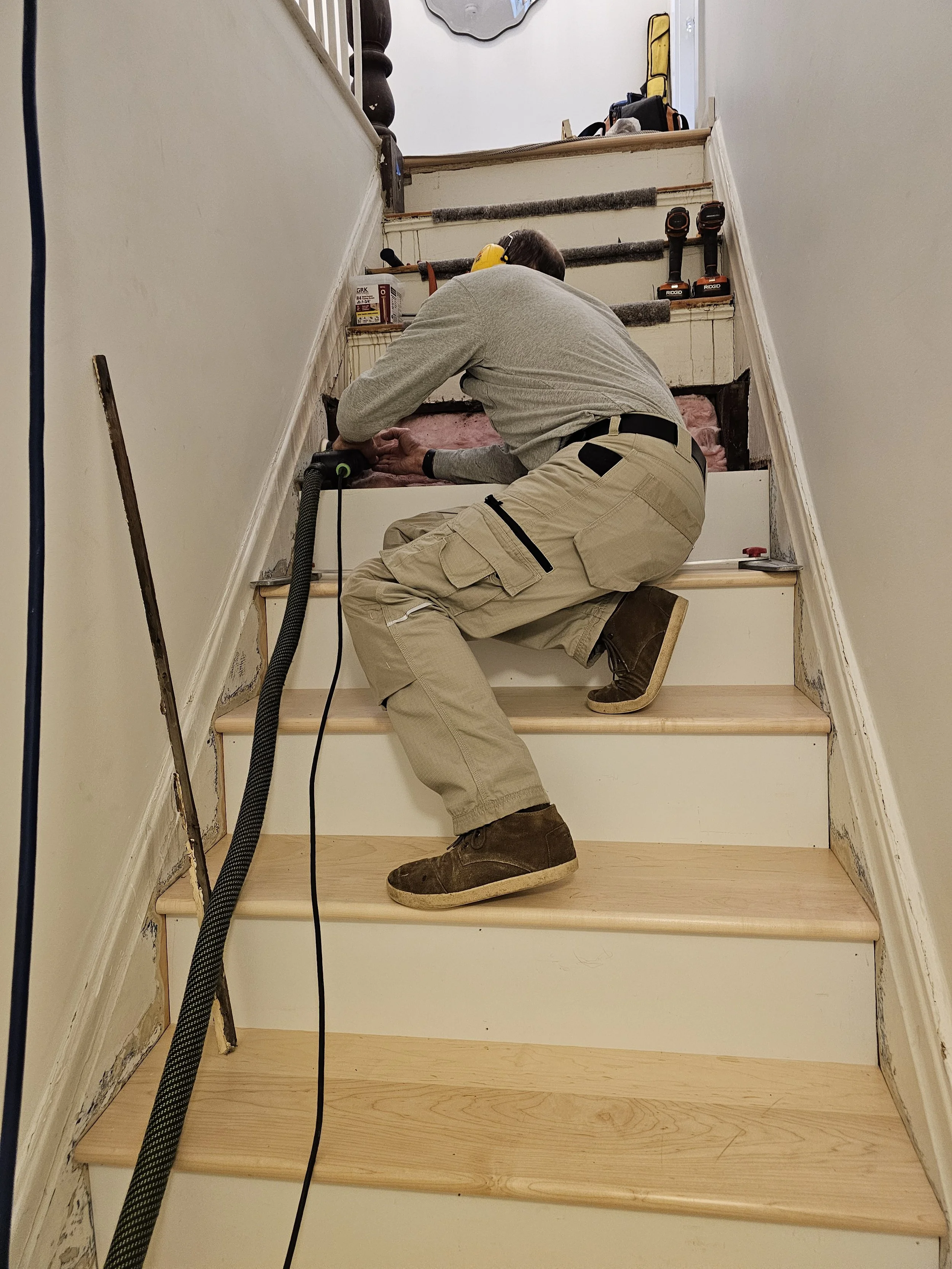 The skirts were held together with duct tape in some areas! This old staircase was ready for a facelift. We added new risers and maple treads and were able to repair the original skirtboards. 