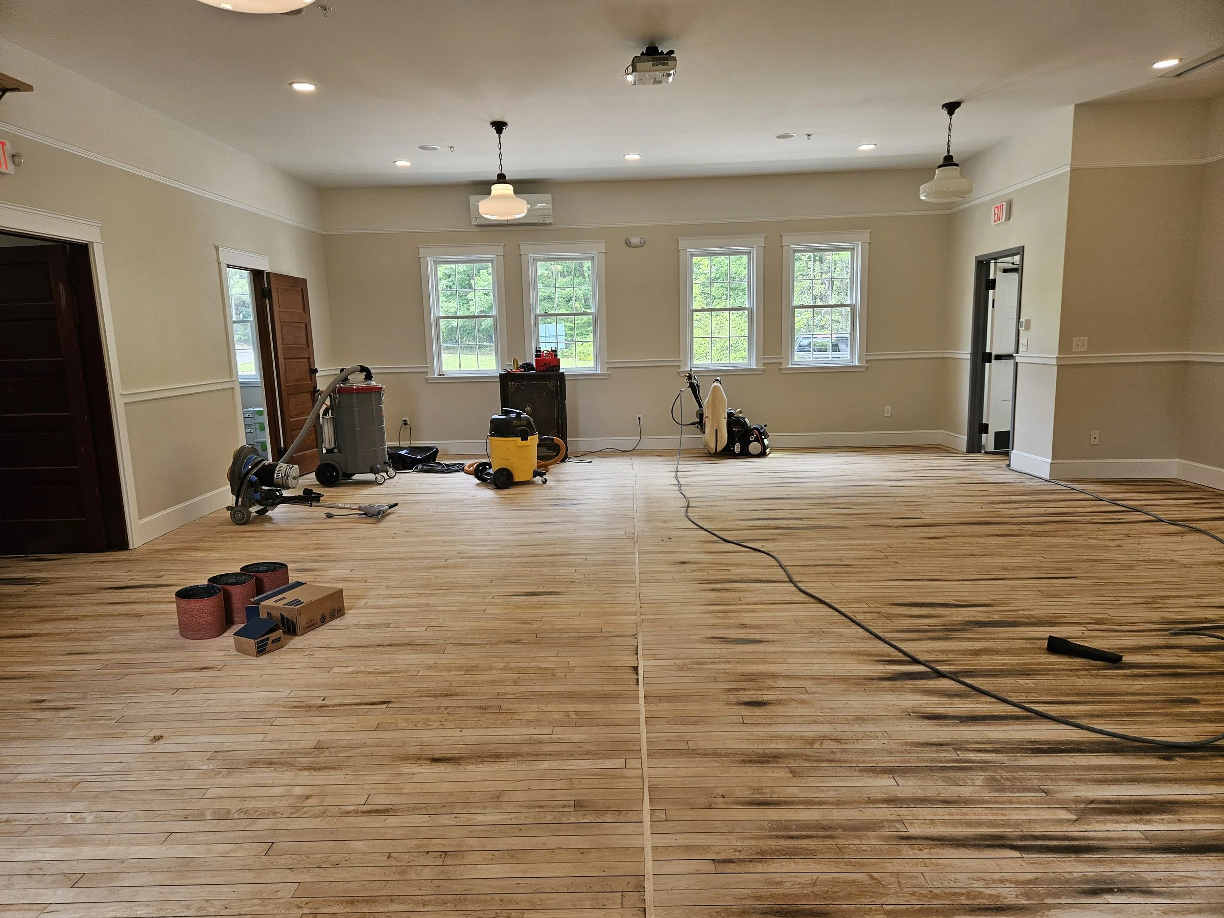 Mid project. The floor has been sanded part of the way with a long way still to go.