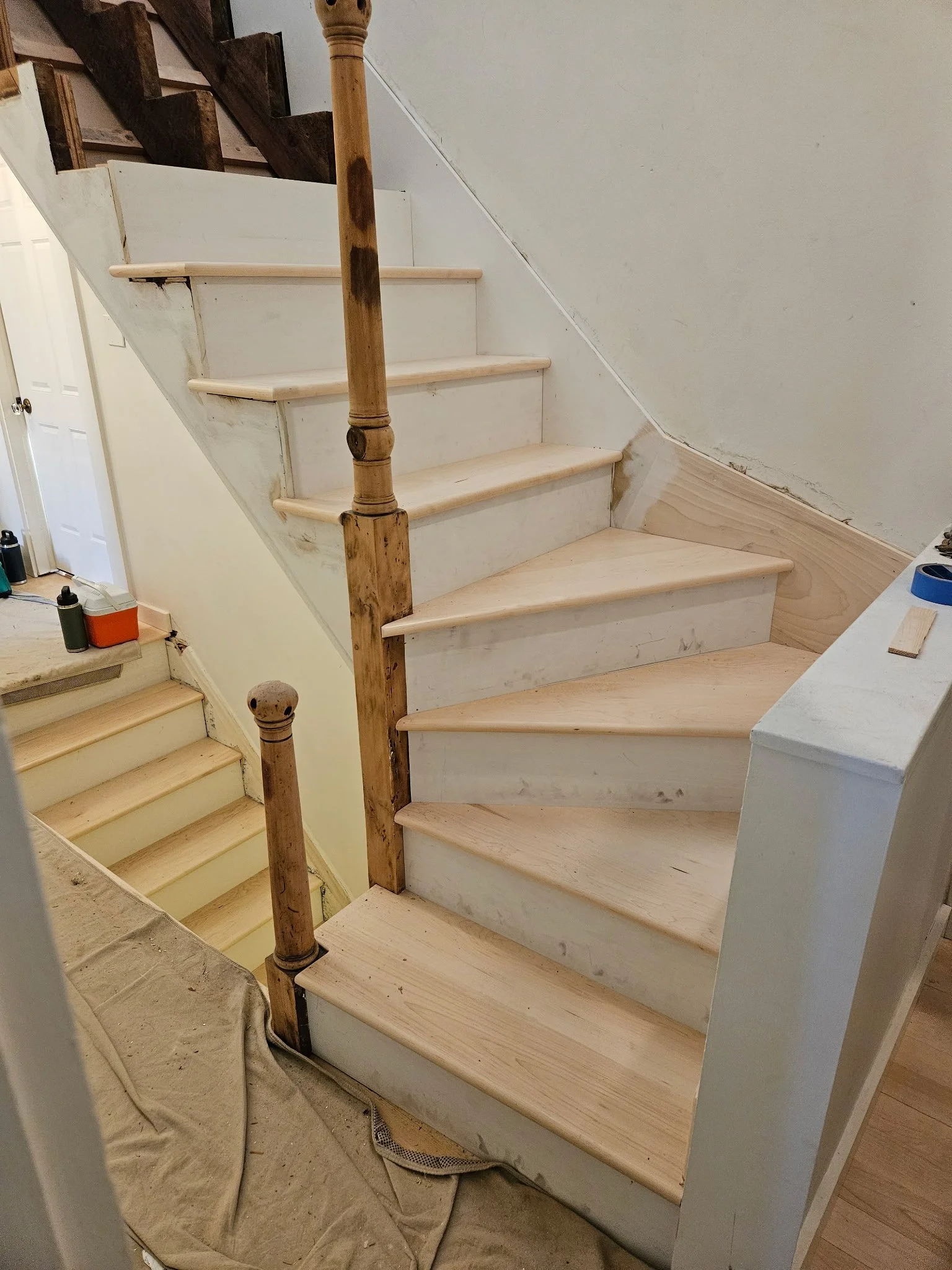 In progress on the handrail system and tread installation. The newel posts couldn't be removed, so we carefully refinished those on site.