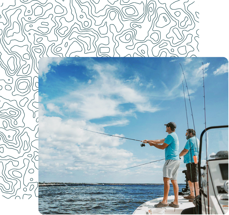 Two men fishing off the side of a boat on a lake or ocean under a partly cloudy sky.