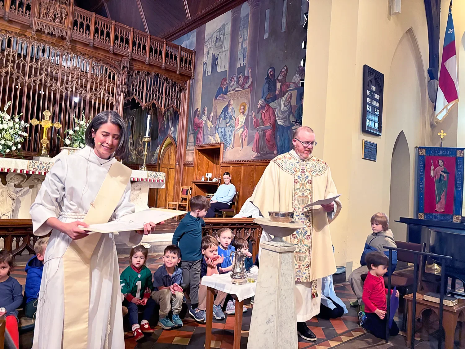 Mother Amy and Father Dave standing during baptism service at St. Thomas’ Church Whitemarsh.