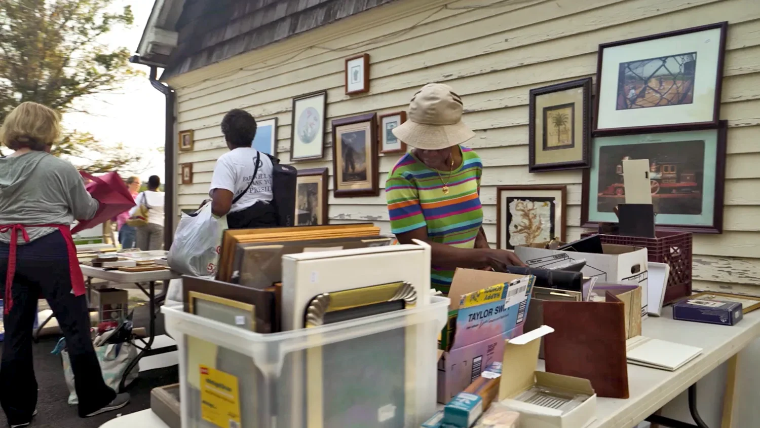 A woman looking through photos for sale  at The Barn at St. Thomas’ Church Whitemarsh.