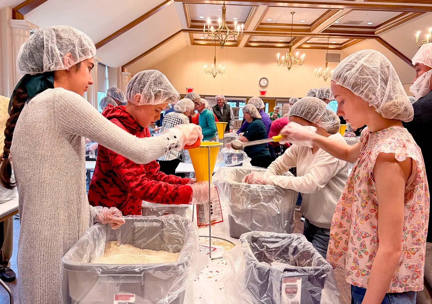 Young parishioners packing food for meals during Pac-a-Thon at St. Thomas’ Church Whitemarsh.