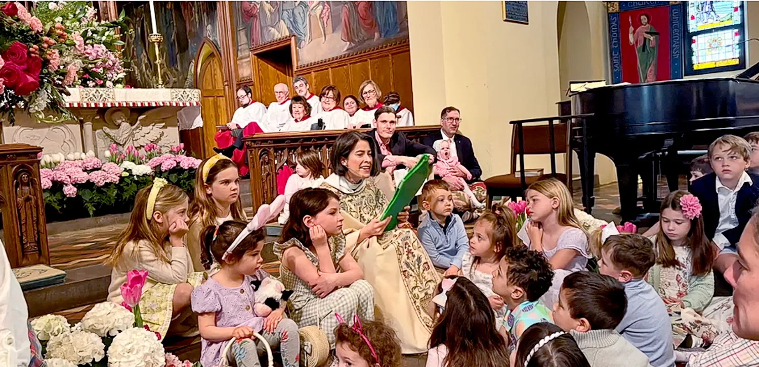 Mother Amy sits on a step surrounded by children during service at St. Thomas’ Church Whitemarsh.