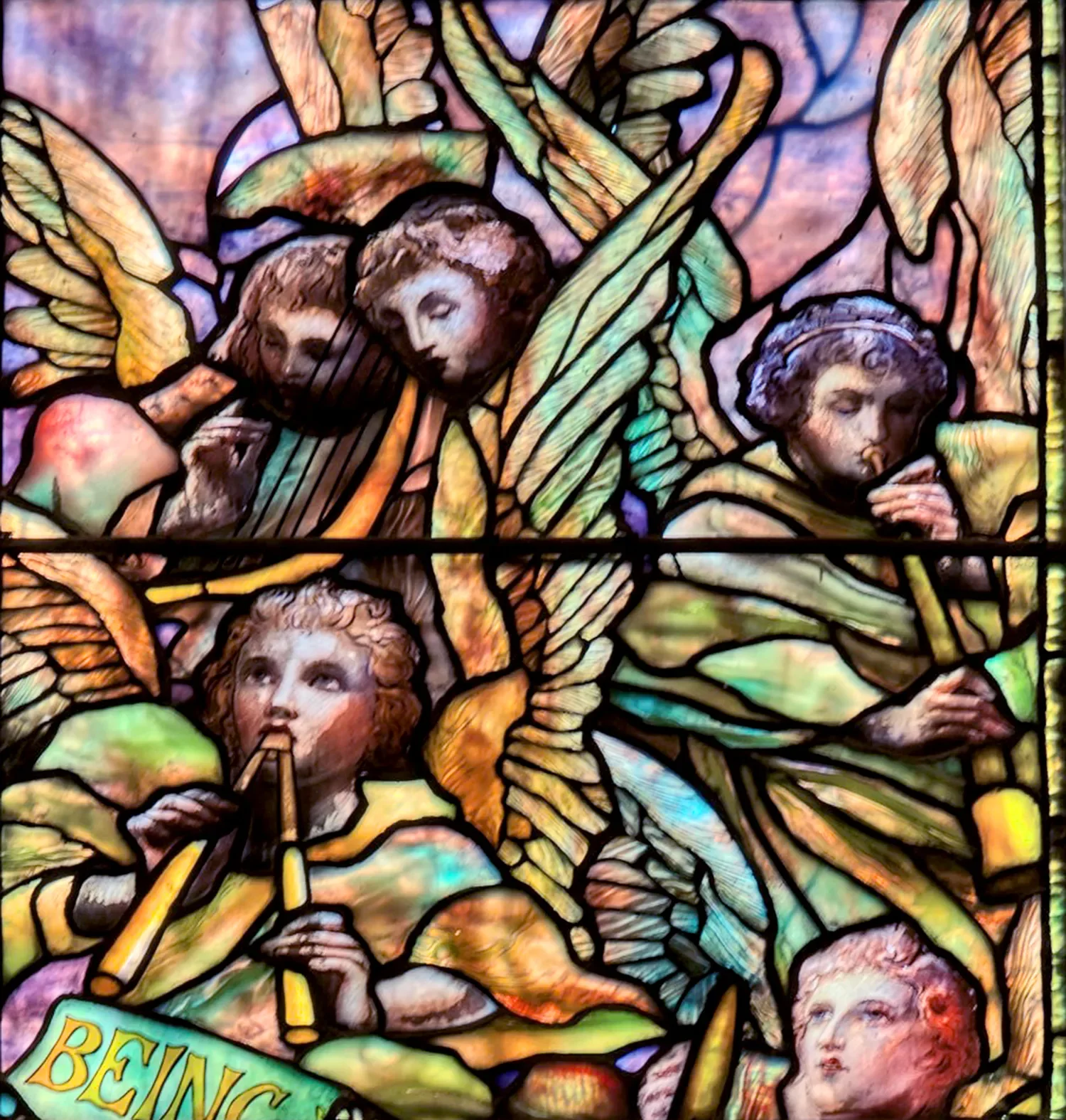 Stained‑glass depiction of angels playing instruments inside the main church at St. Thomas’ Church Whitemarsh.