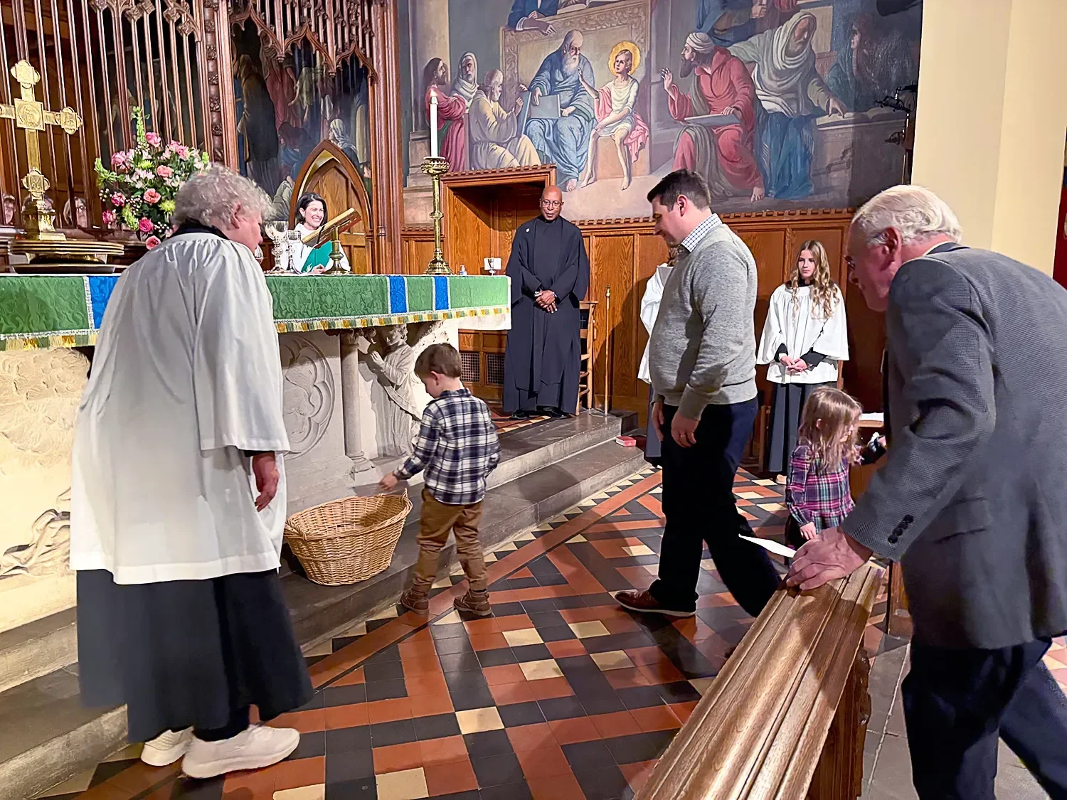 Congregants approaching a basket to hand in donations at St. Thomas’ Church Whitemarsh.