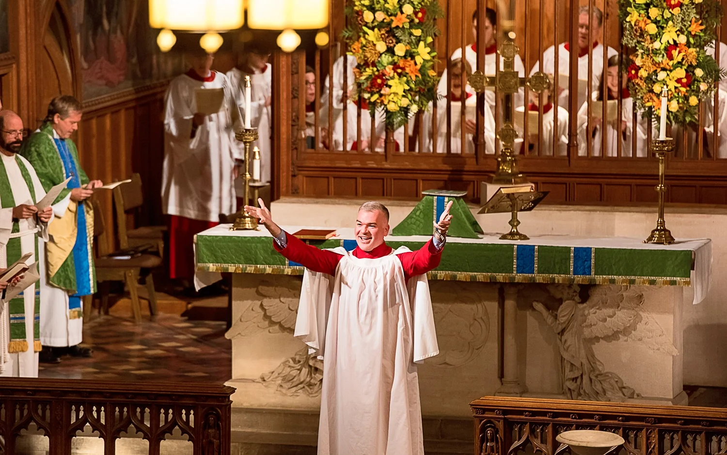 Michael Smith, Minister of Music, directing choir in the main church with both arms raised at St. Thomas’ Church Whitemarsh.
