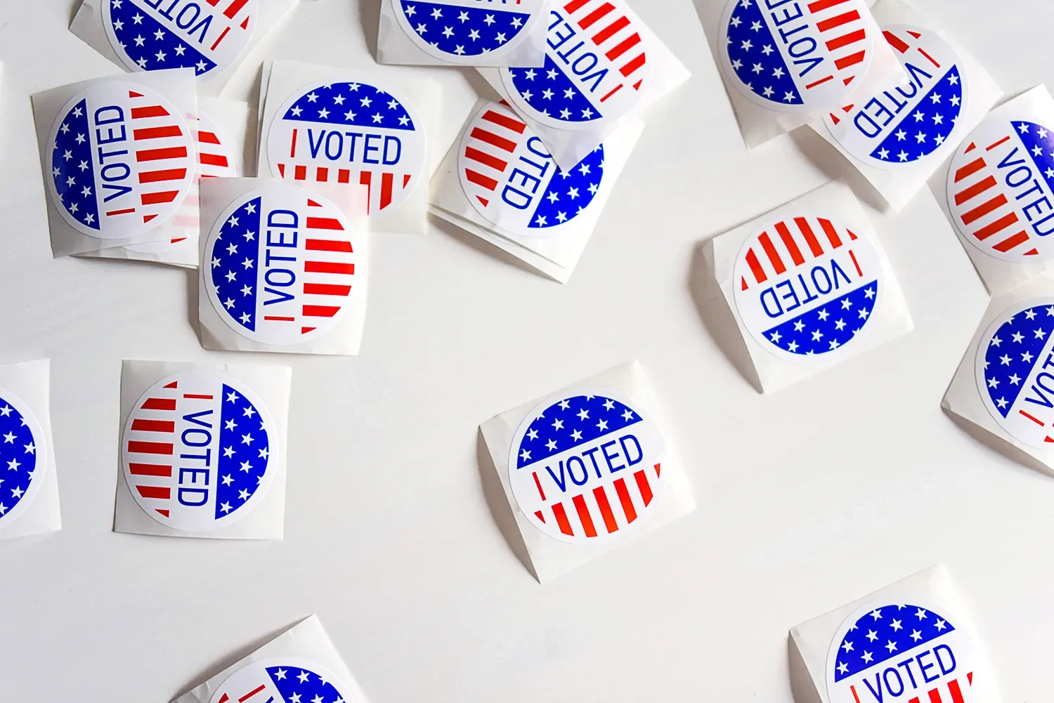 Numerous “I Voted” stickers on a white table.