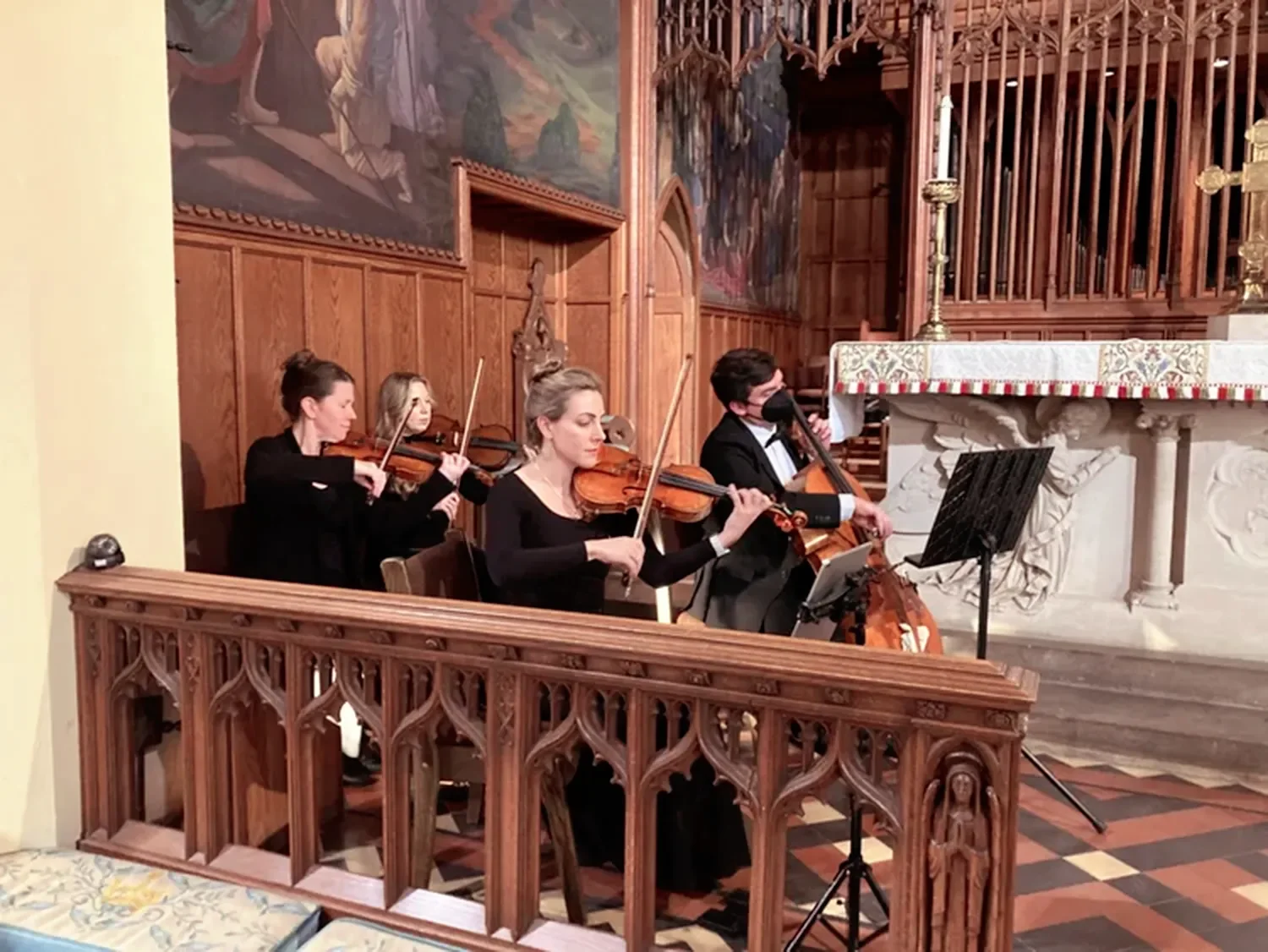 String quartet playing during wedding ceremony in main church at The Retreat at St. Thomas’ Church Whitemarsh.