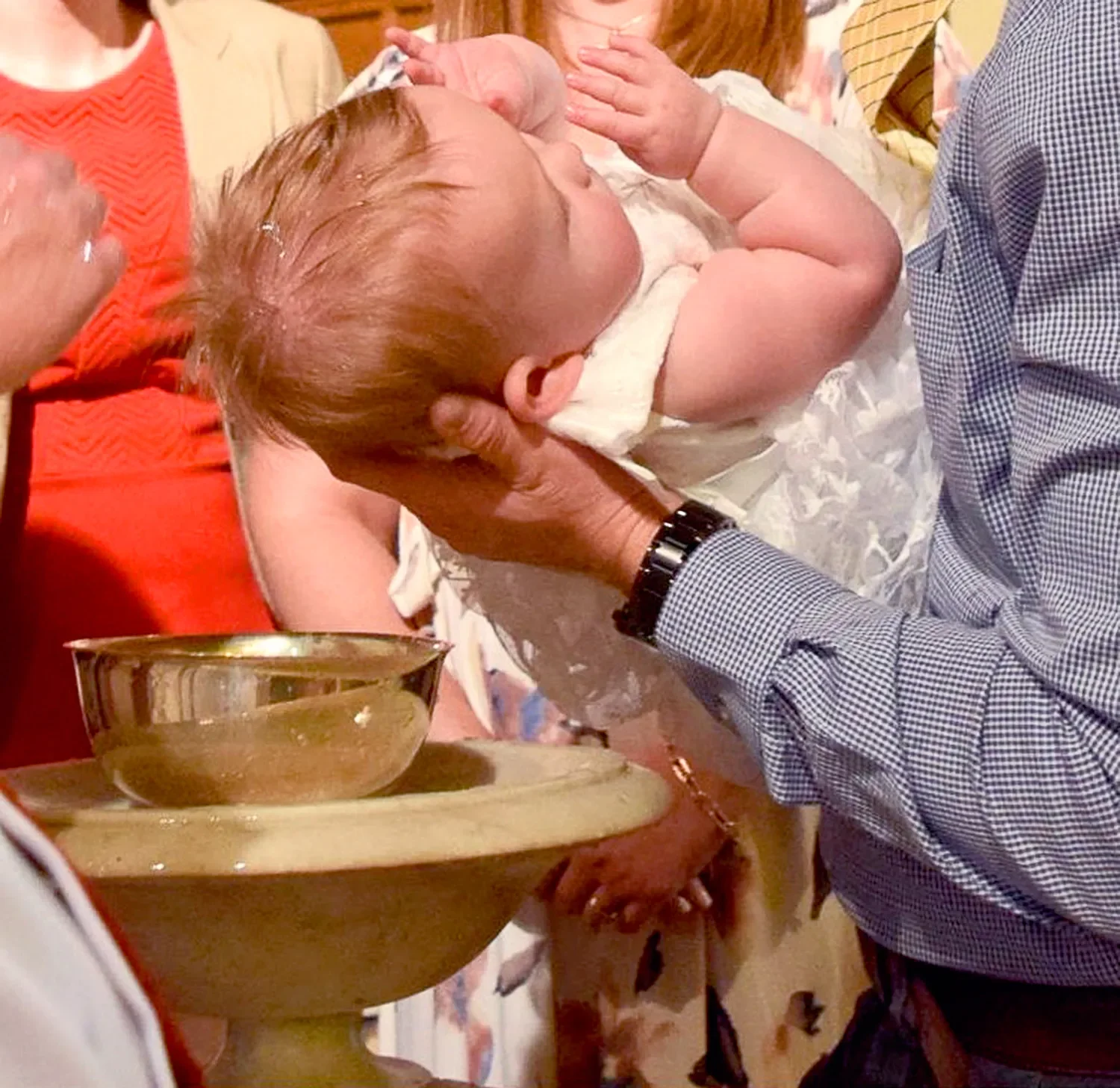 Closeup of a baby's head that is getting baptized at St. Thomas’ Church Whitemarsh.