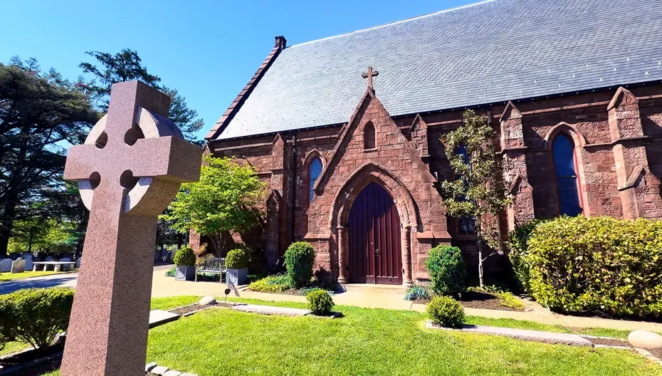 The Peace Garden at St. Thomas’ Church Whitemarsh featuring a large stone cross monument in front of the church.