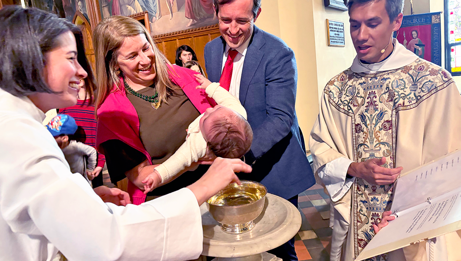 Mother Amy baptizing a baby held by its parents at St. Thomas’ Church Whitemarsh.