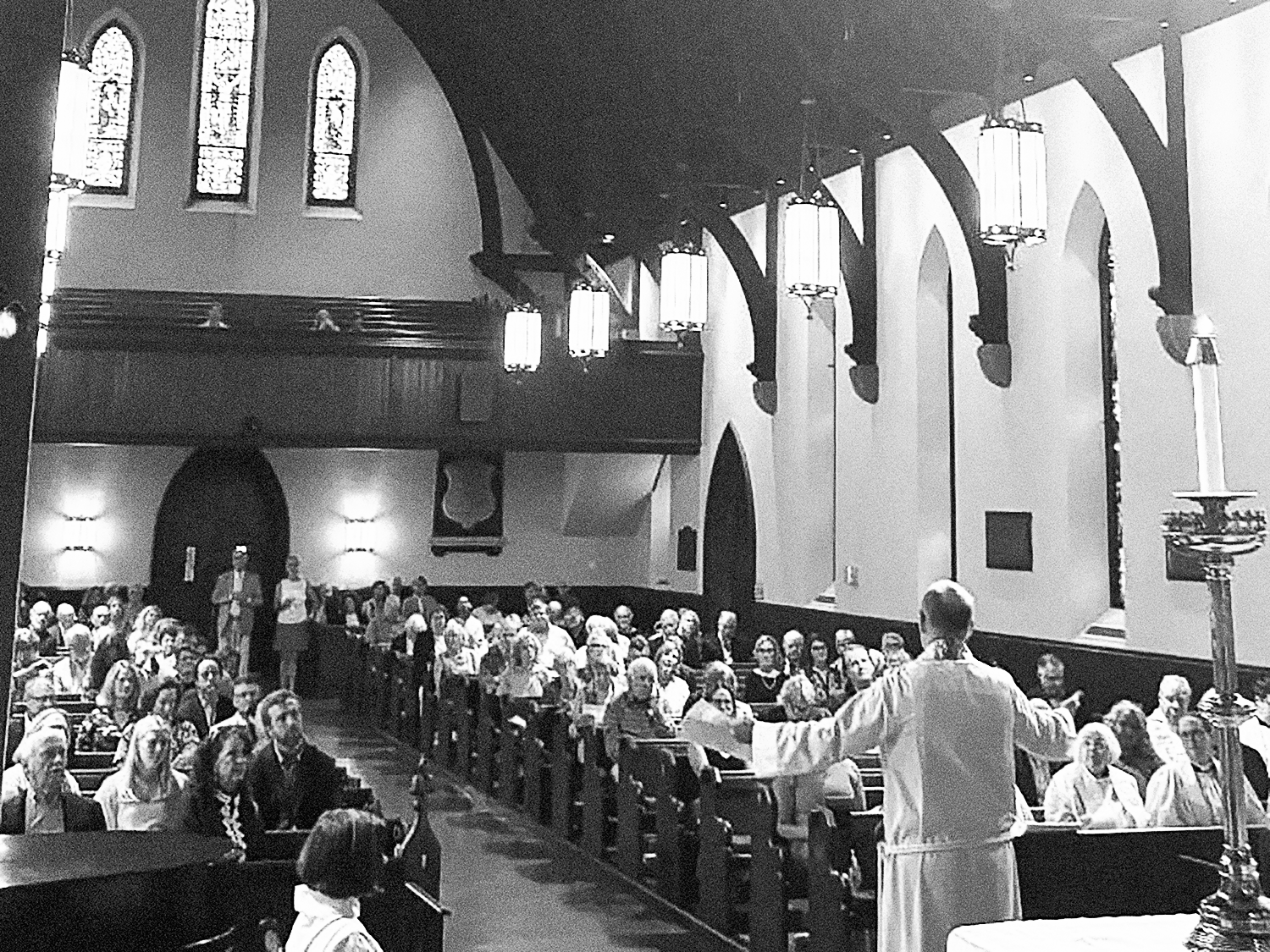 Father Dave addressing the parish with his arms raised and outstretched during a service at St. Thomas’ Church Whitemarsh.