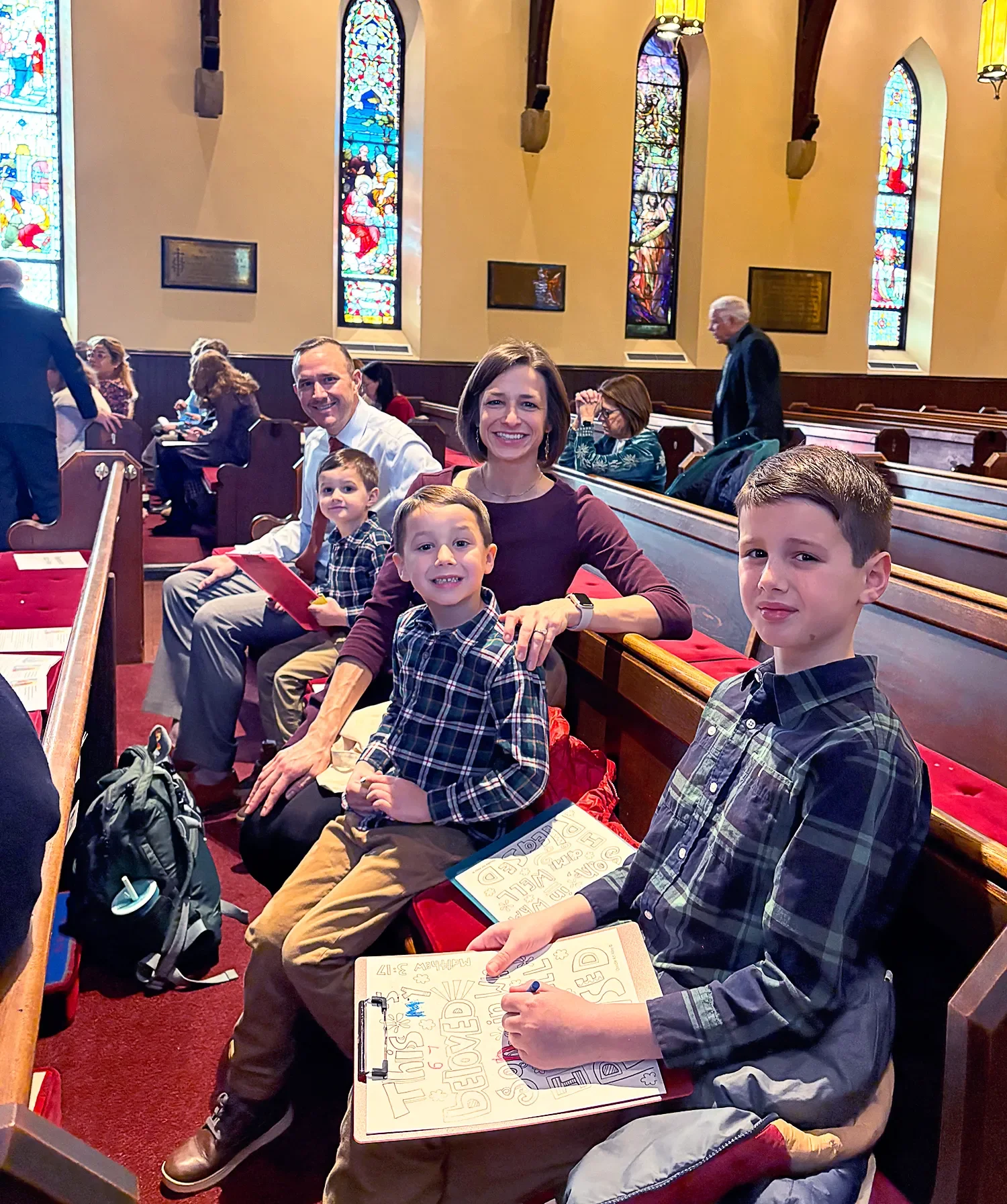 Family seated in a pew at St. Thomas’ Church Whitemarsh.