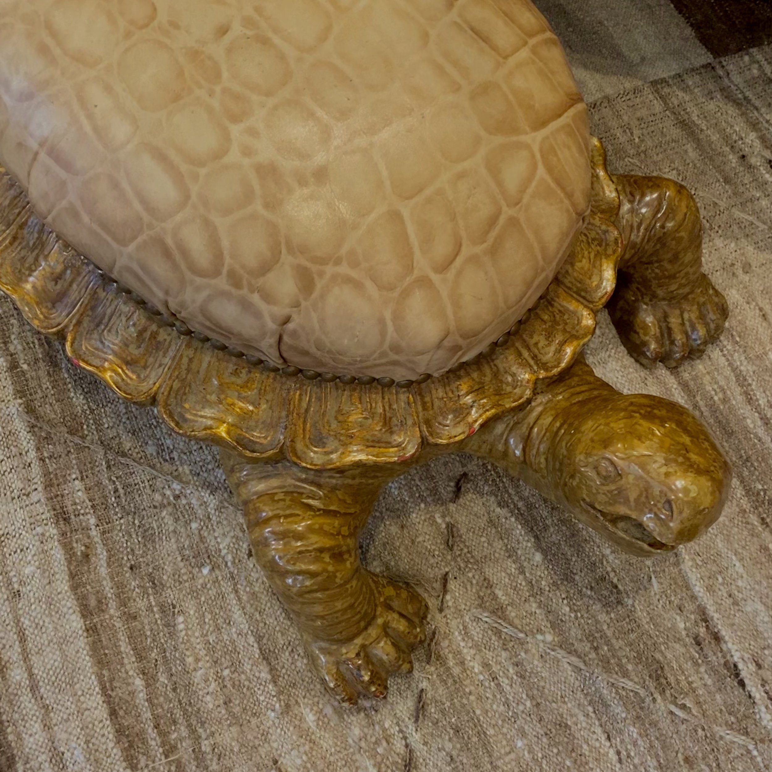 A close-up image of a yellow plastic giraffe figurine partially covered by a honeycomb-patterned cloth.