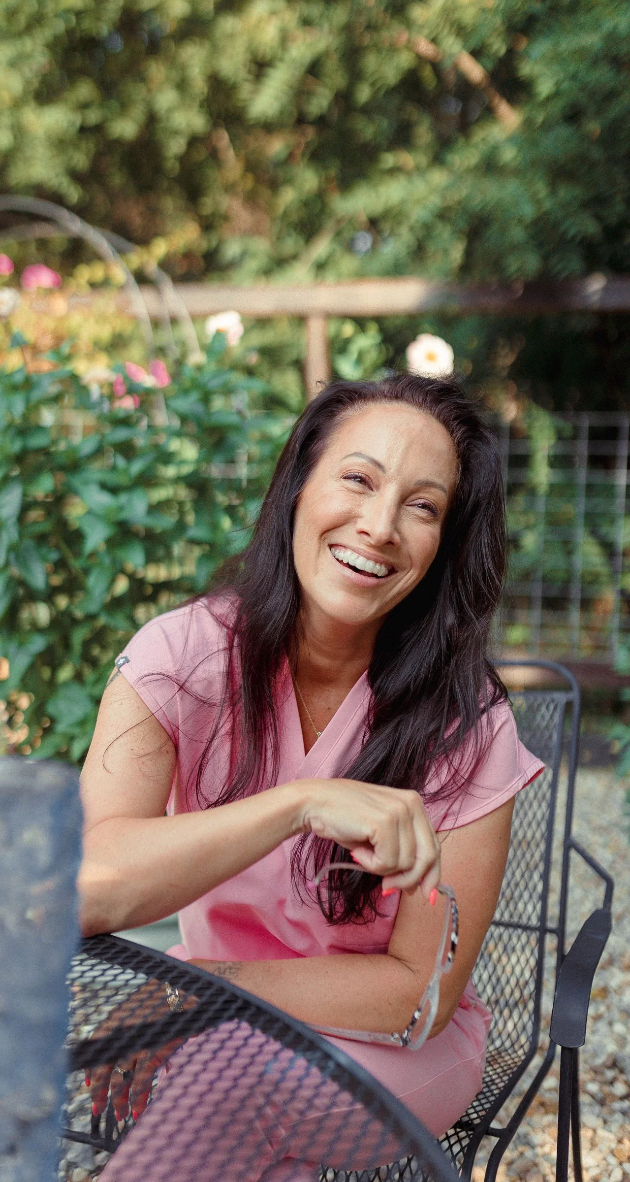 Dr. Siân West, host of This Meno Life, laughing in her garden