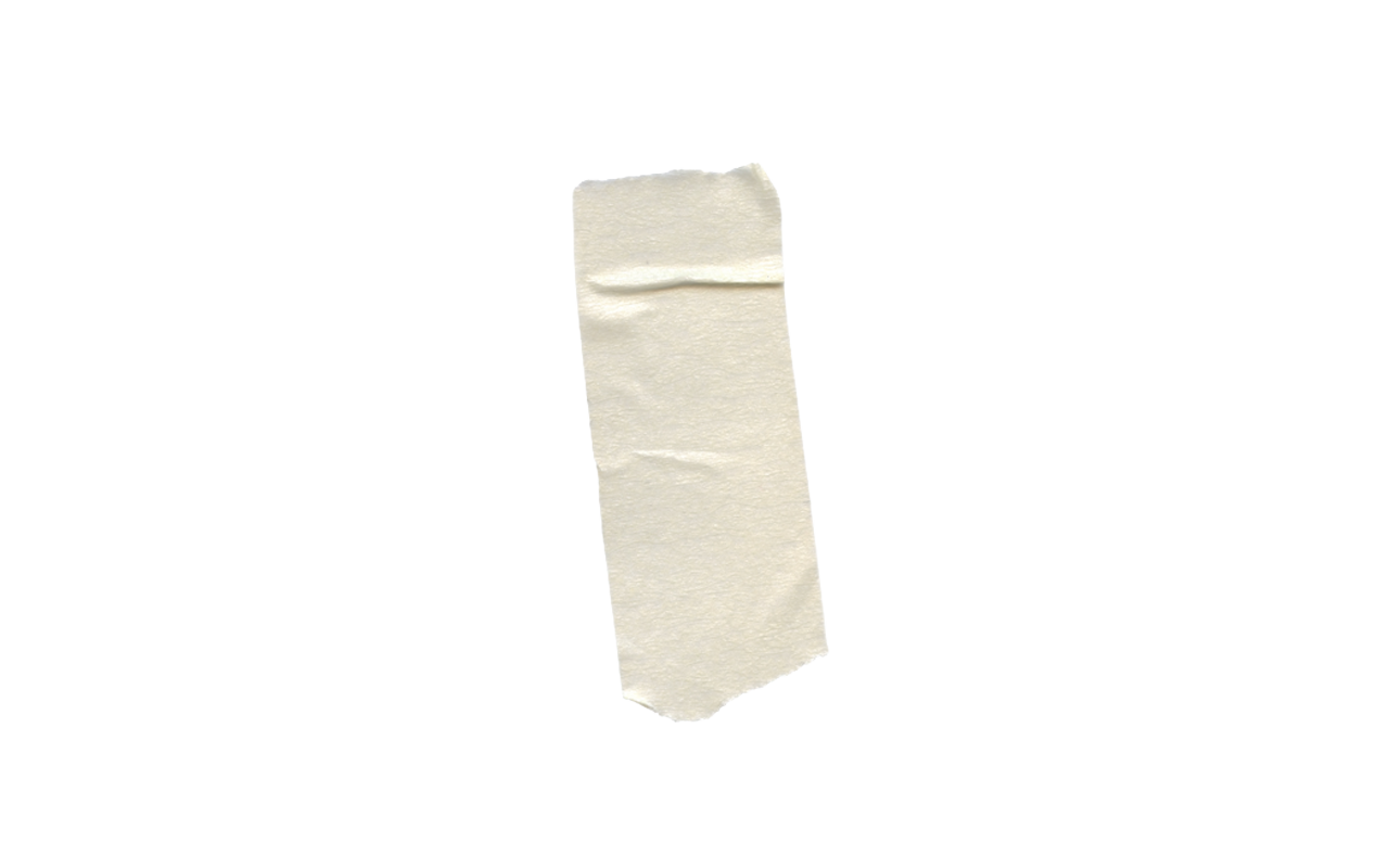 Close-up of a piece of white paper glued onto a flat surface, with a blurred background.