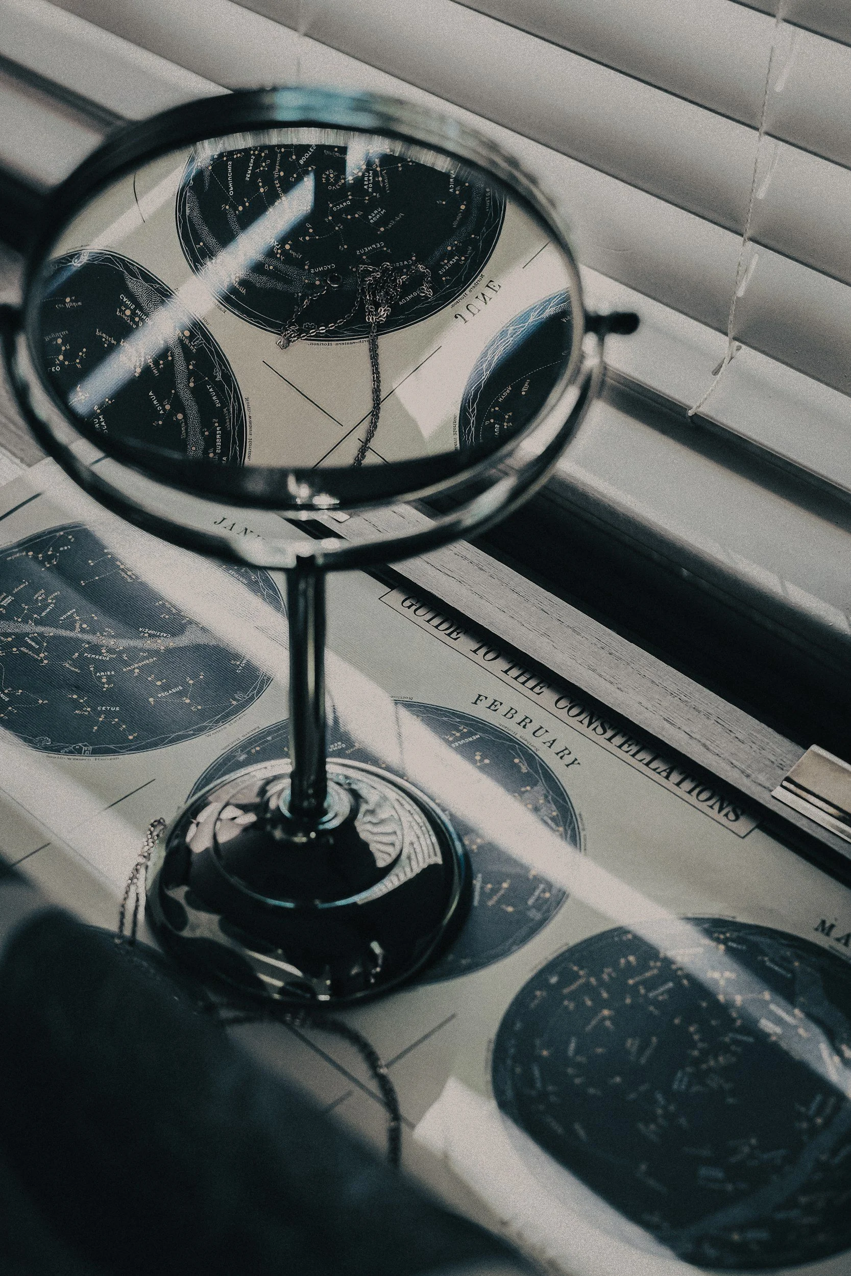 An analytical display of astronomical charts reflected in a clean studio mirror, symbolizing deep financial mapping, structural navigation, and finding order within complex data.