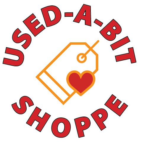 Logo for Used-A-Bit Shoppe featuring a price tag with a heart in the center, surrounded by red text reading "Used-A-Bit Shoppe."