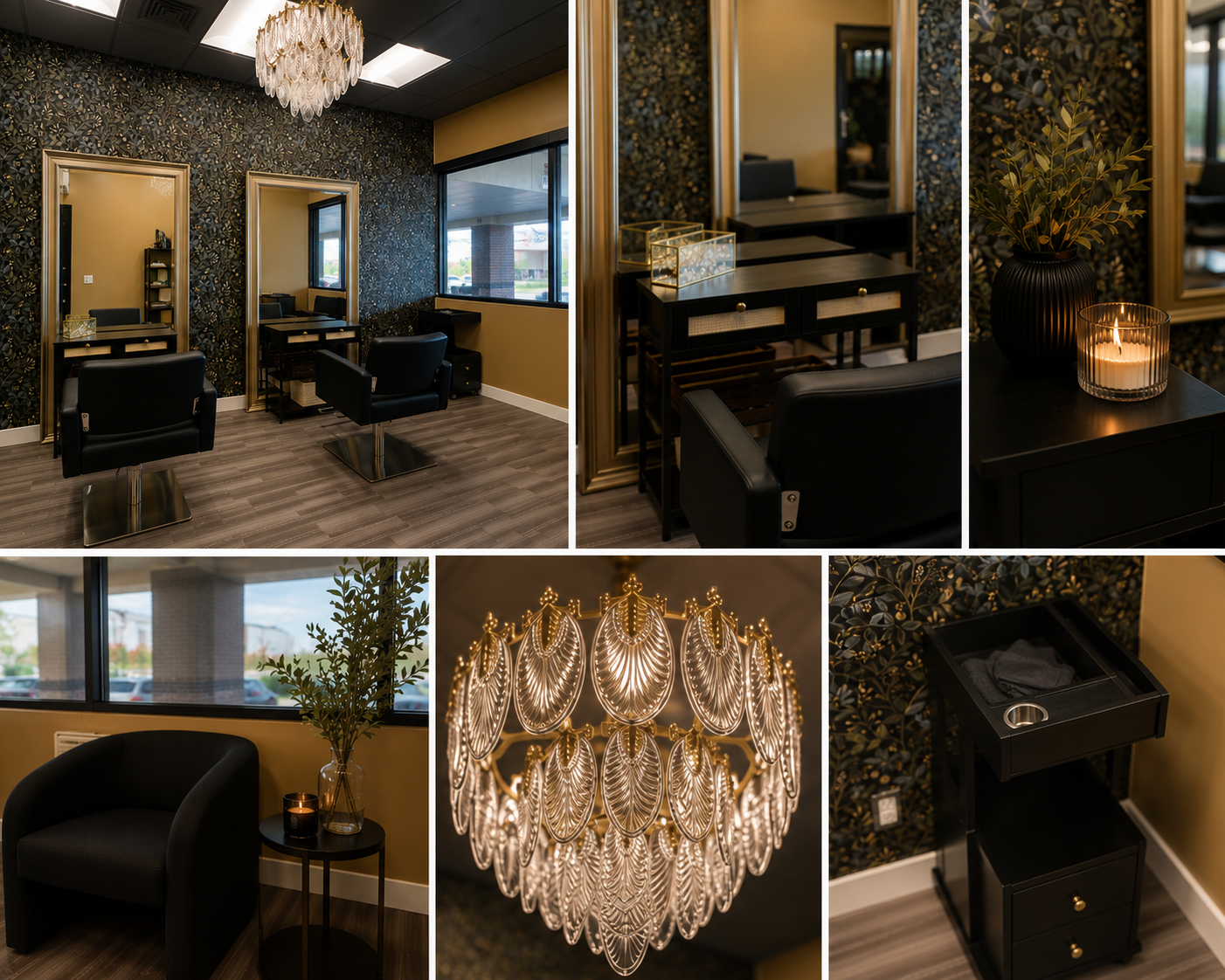 A stylish beauty salon interior with black salon chairs facing mirrors on a dark floral patterned wall, a side table with a candle and a black vase with branches, a window with a view of a parking lot, a decorative chandelier, and a black vanity with drawers.