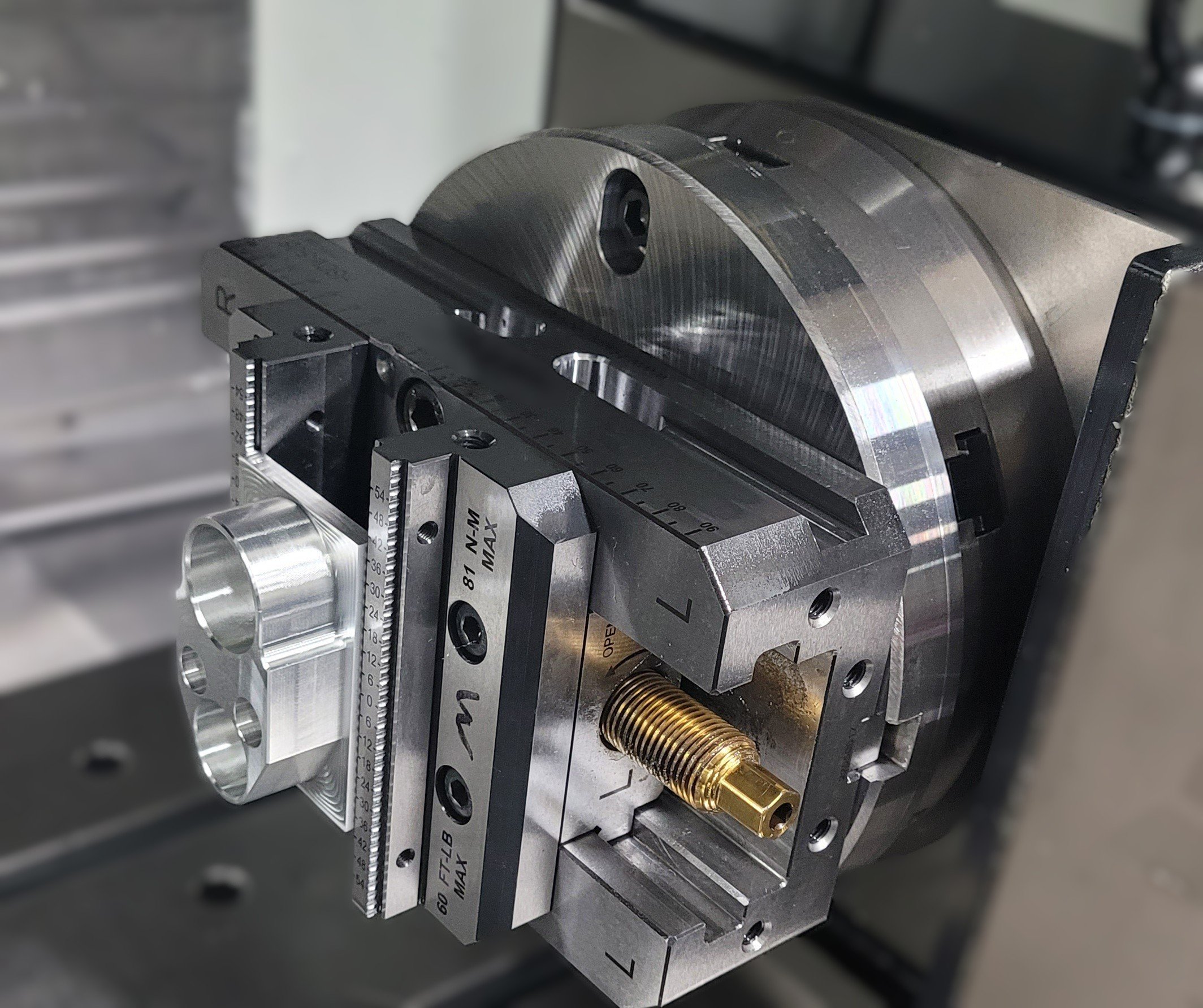 Advanced CNC milling machine with 4th-axis rotary fixture machining a complex precision component.