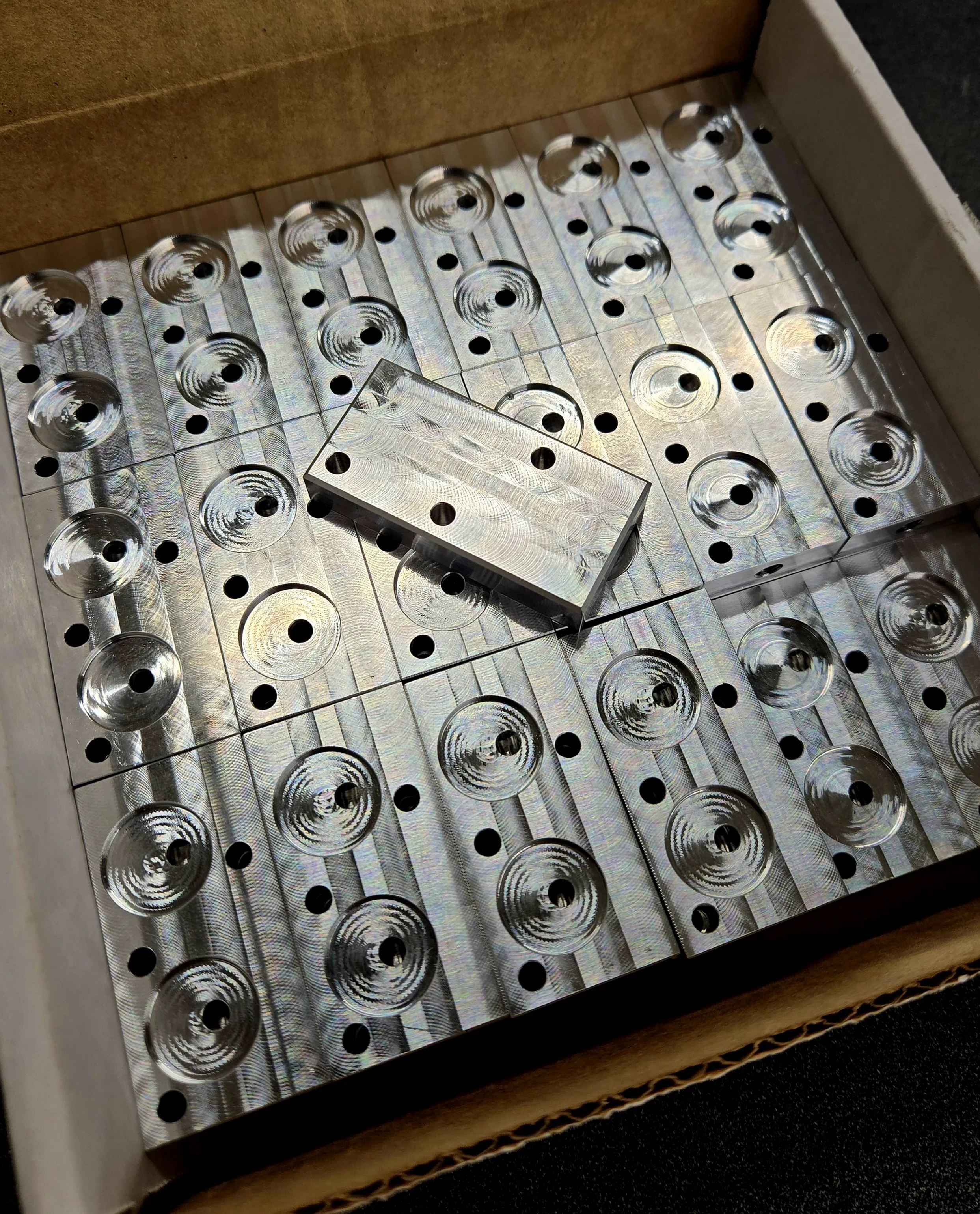 Precision machined metal components prepared for prototype development and full-scale production manufacturing.