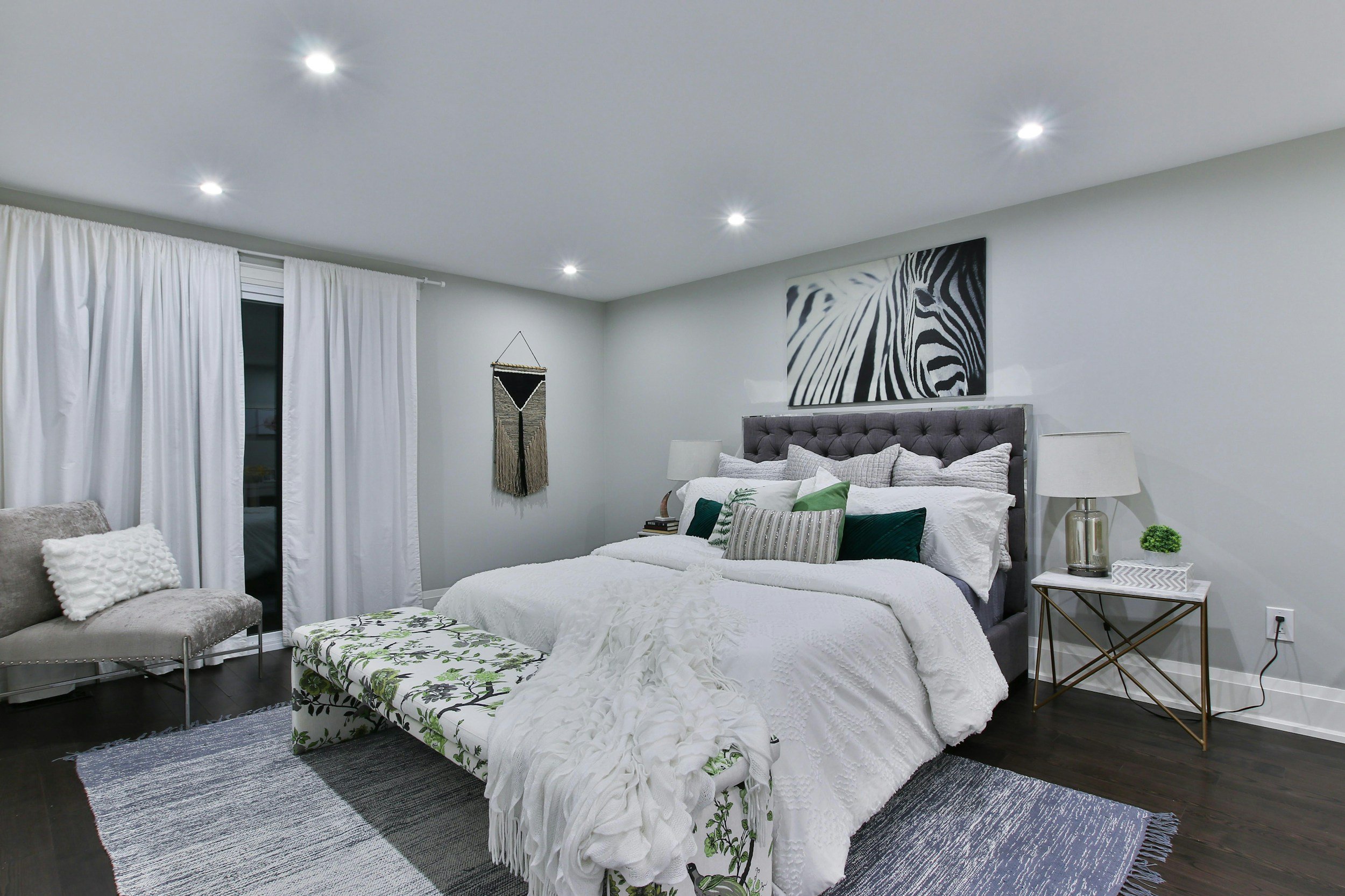 Blueprint Elite Realty — Georgia's luxury boutique real estate brokerage — Staged luxury bedroom with recessed lighting, modern bedding decor, tufted headboard and neutral color palette