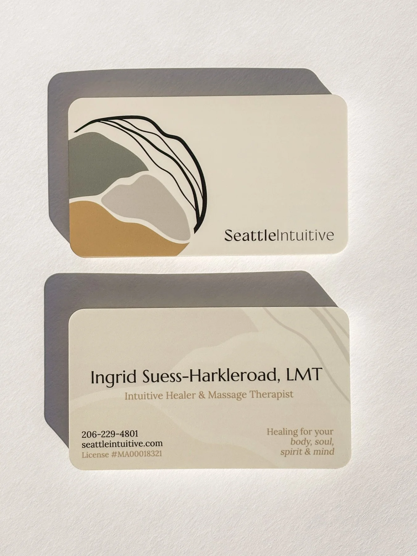 Seattle Intuitive business card design, front and back, featuring an abstract line-art landscape illustration and contact details for massage therapist Ingrid Suess-Harkleroad