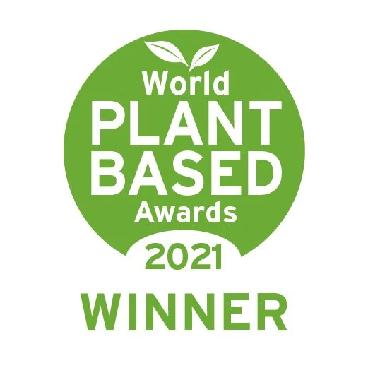 Green circular logo for the World Plant Based Awards 2021 with text indicating 'WINNER' and a graphic of two leaves.