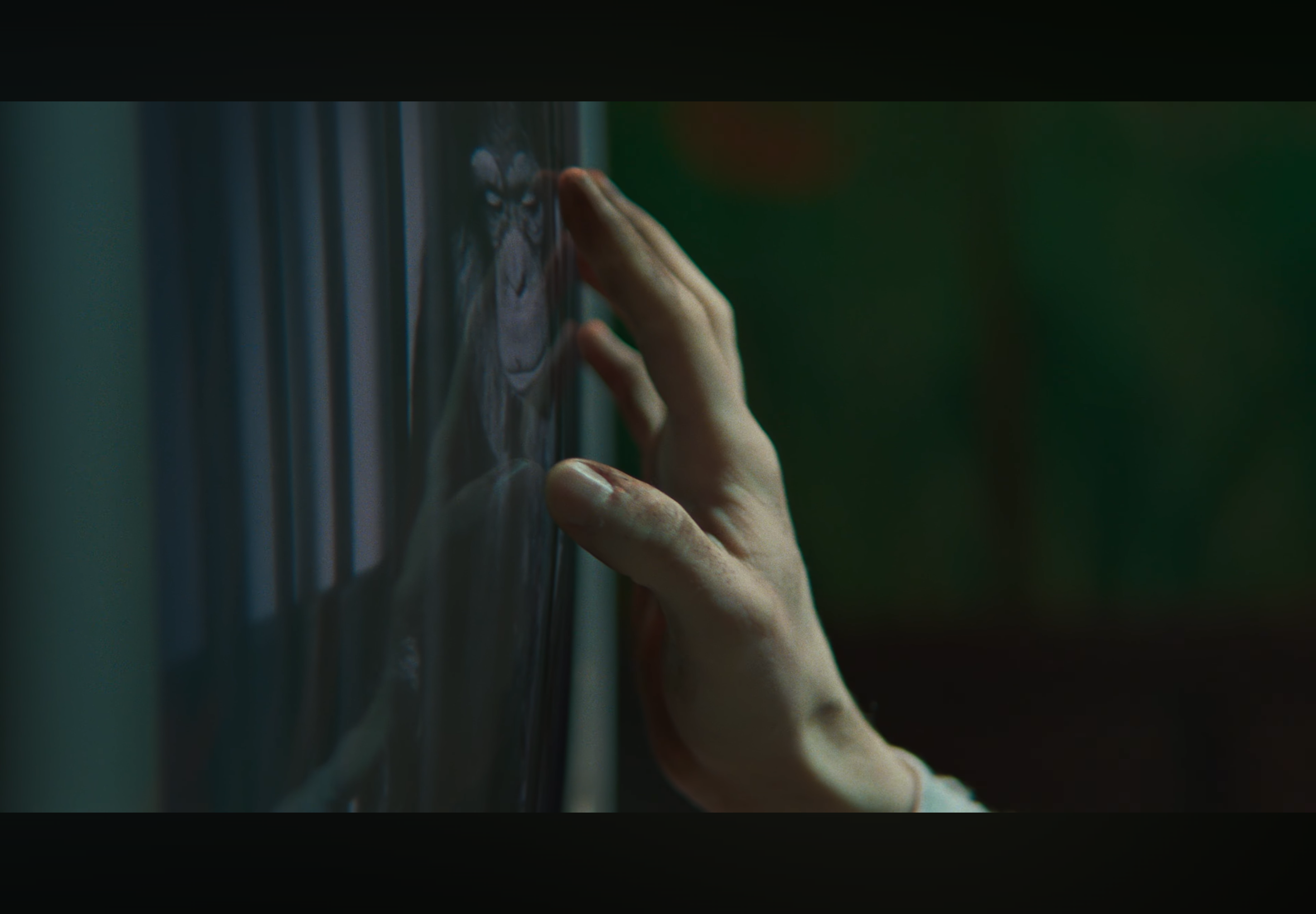 A hand touching a panel displaying a wolf's face.