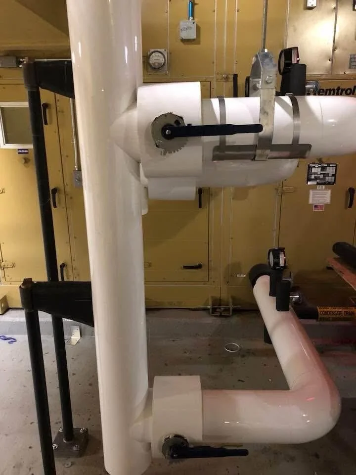 PVC-jacketed mechanical piping insulation installed by Vali Shield, LLC. Designed for condensation control system protection and long-term performance in commercial and industrial facilities.