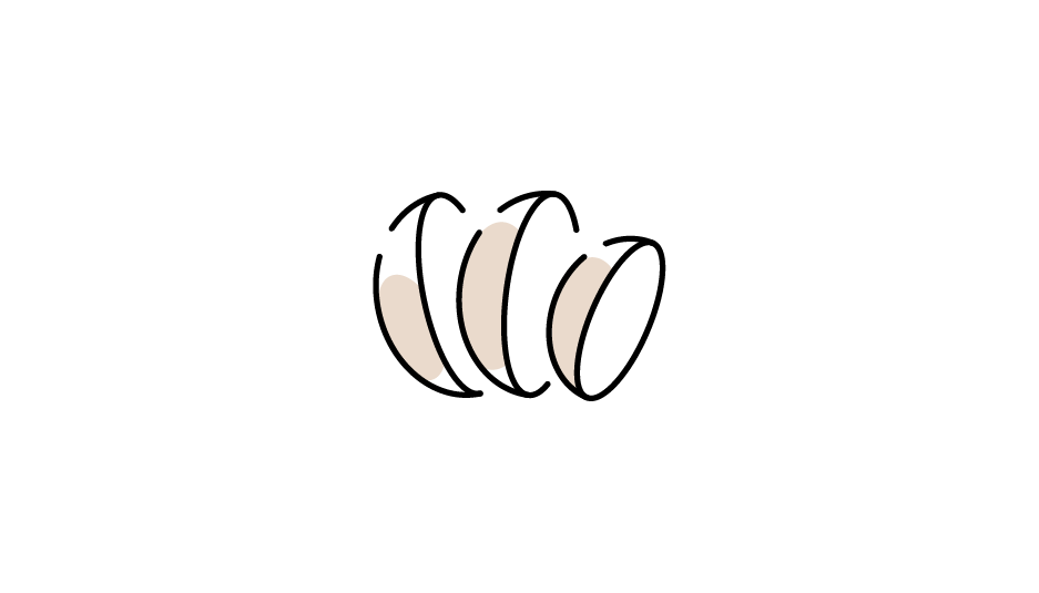 A black cat with glowing eyes sitting on a black background.