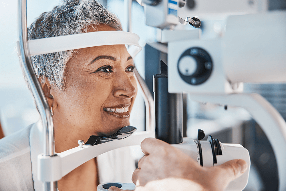 Optometrist performing eye examination using a slit lamp.