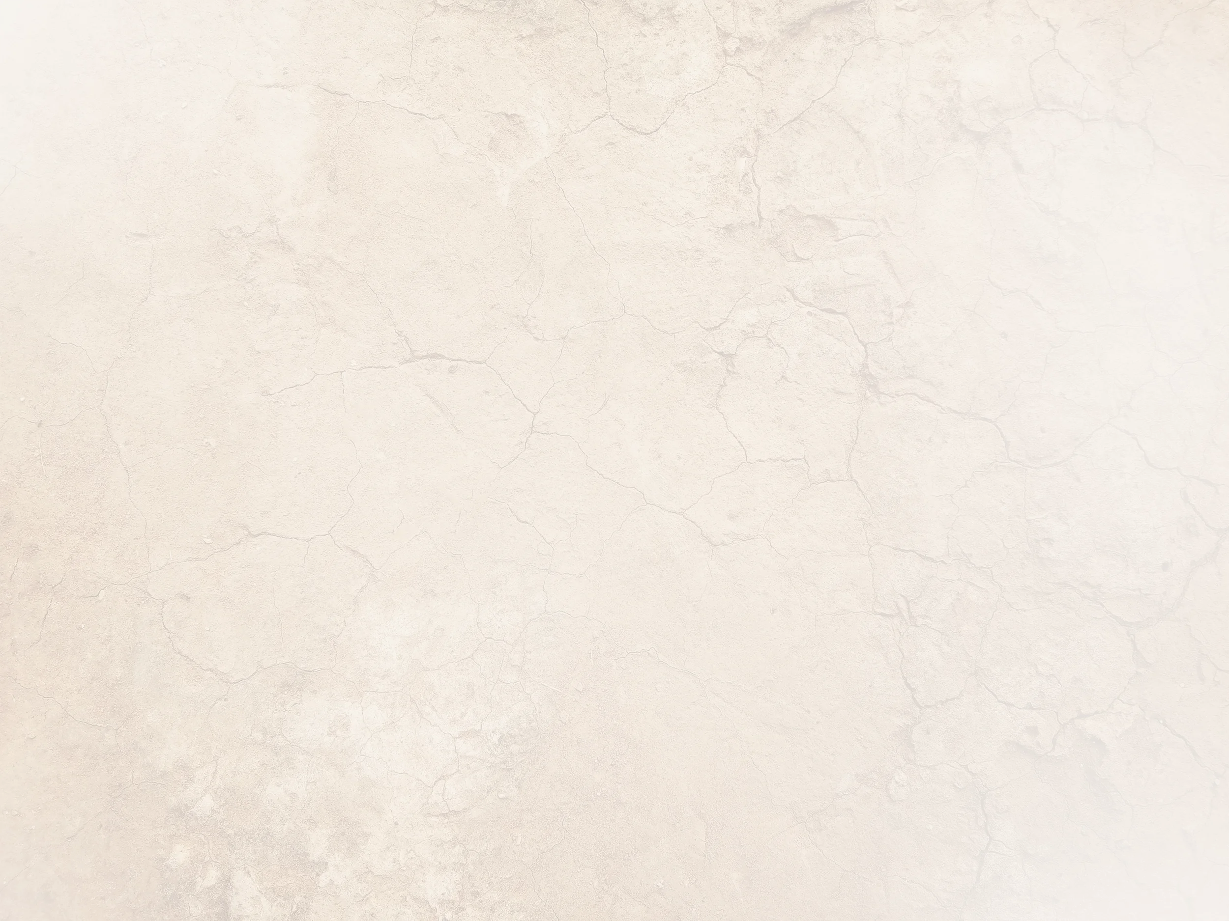 Empty beige textured wall with visible cracks.