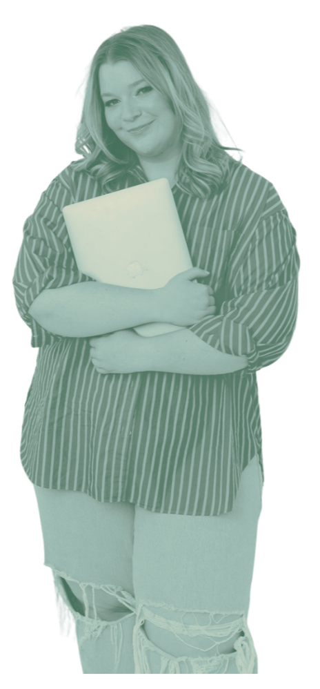 Young woman with wavy hair smiling, holding a laptop close to her chest, wearing a striped shirt and ripped jeans.