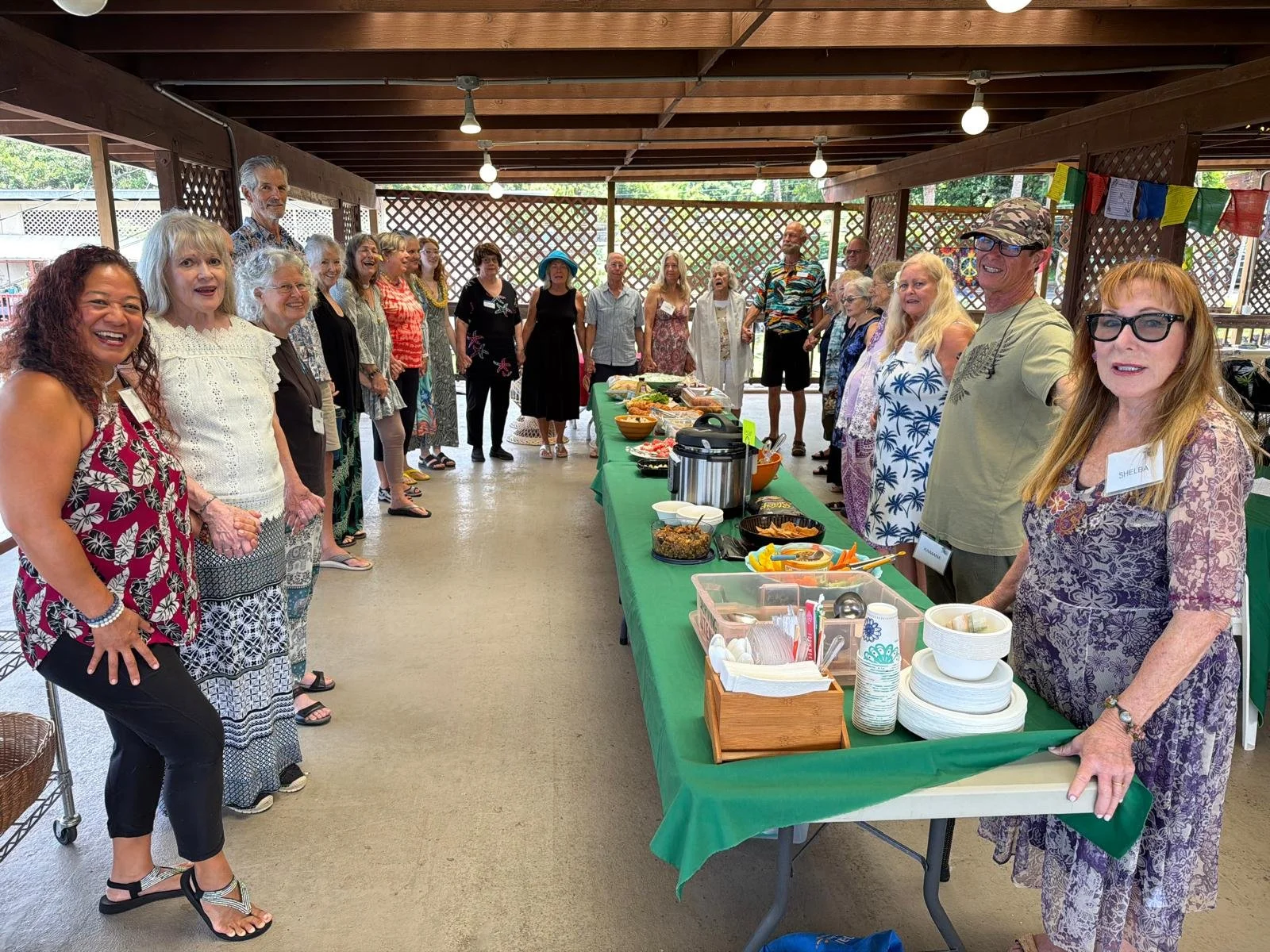 Group of people gathered for a Sunday Potluck at the New Thought Center of Hawaiʻi.