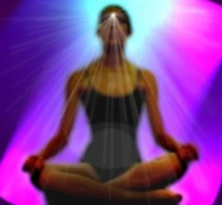 Person meditating in a cross-legged position with colorful purple and pink light rays radiating in the background.