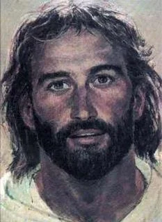 A portrait of a man with long, wavy hair and a beard, looking forward.