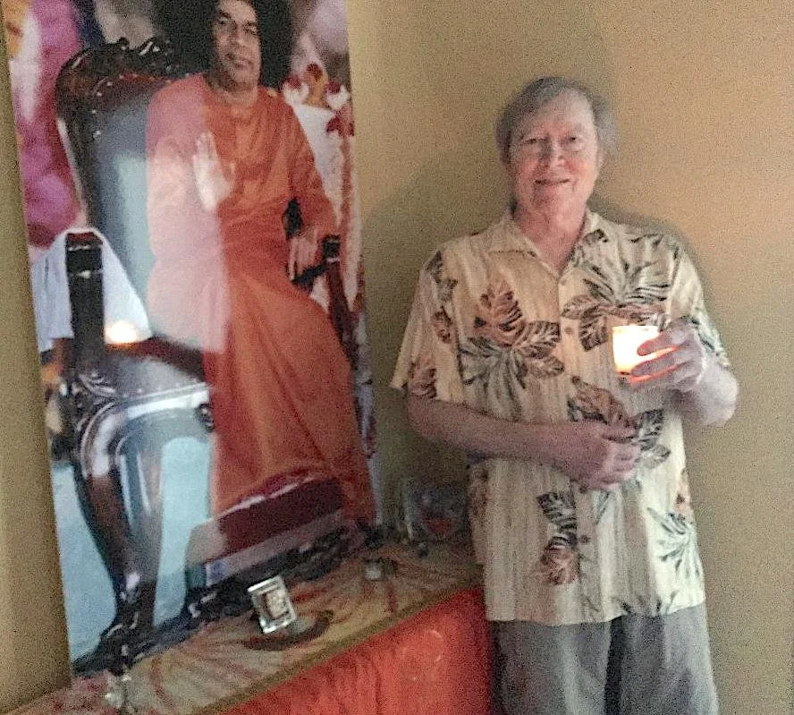 Community member holding candle during memorial service at New Thought Center of Hawaiʻi