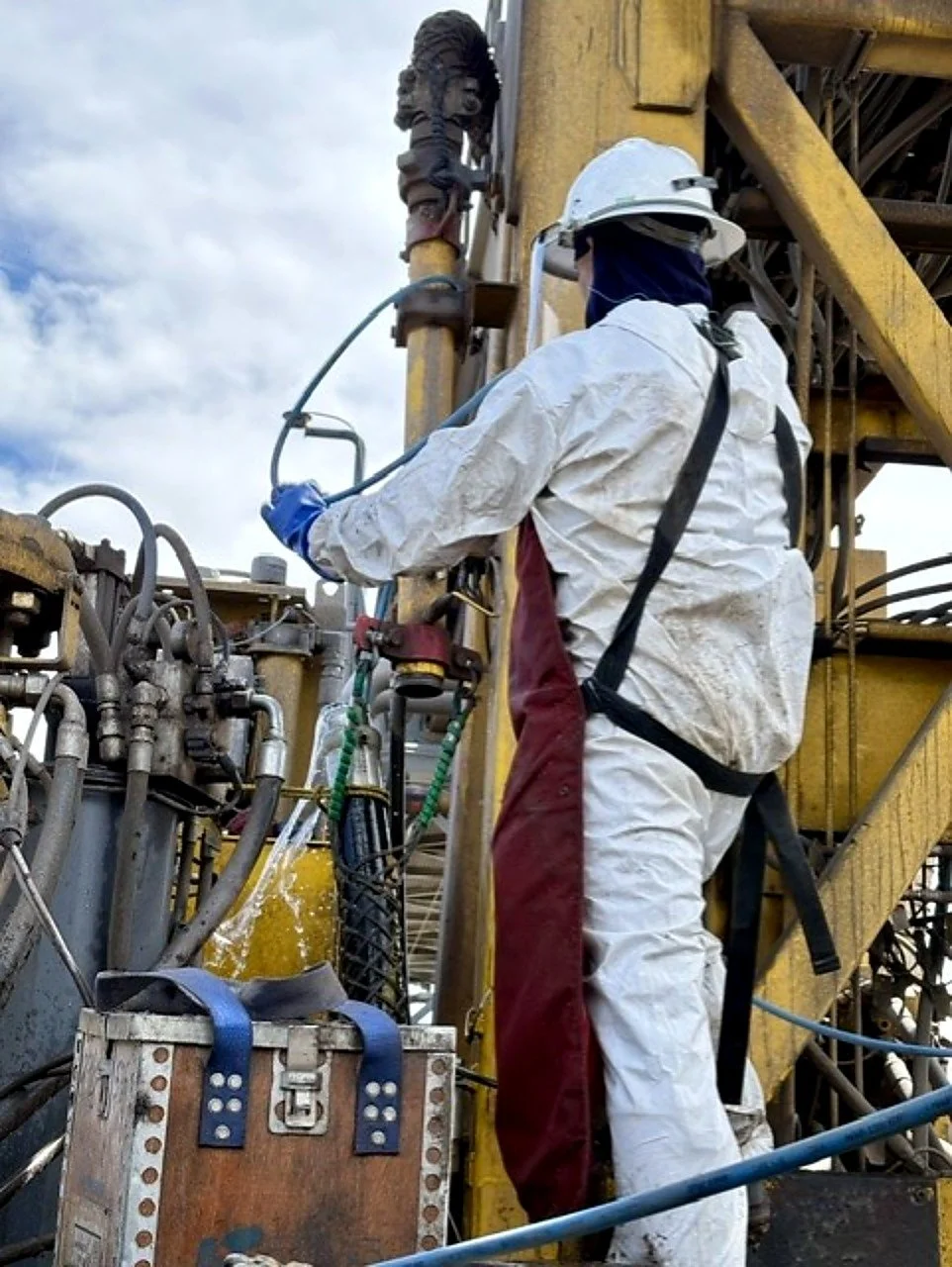 Prime Industrial employee in Northern Nevada wearing protective gear inspecting equipment on an industrial rig.