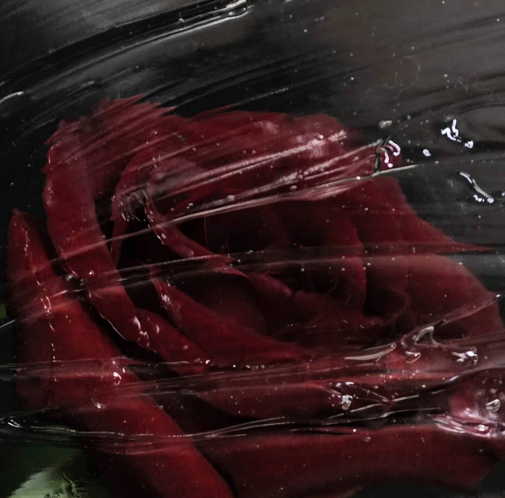 Close-up of a dark abstract painting with red streaks and white splatters on a textured black background.
