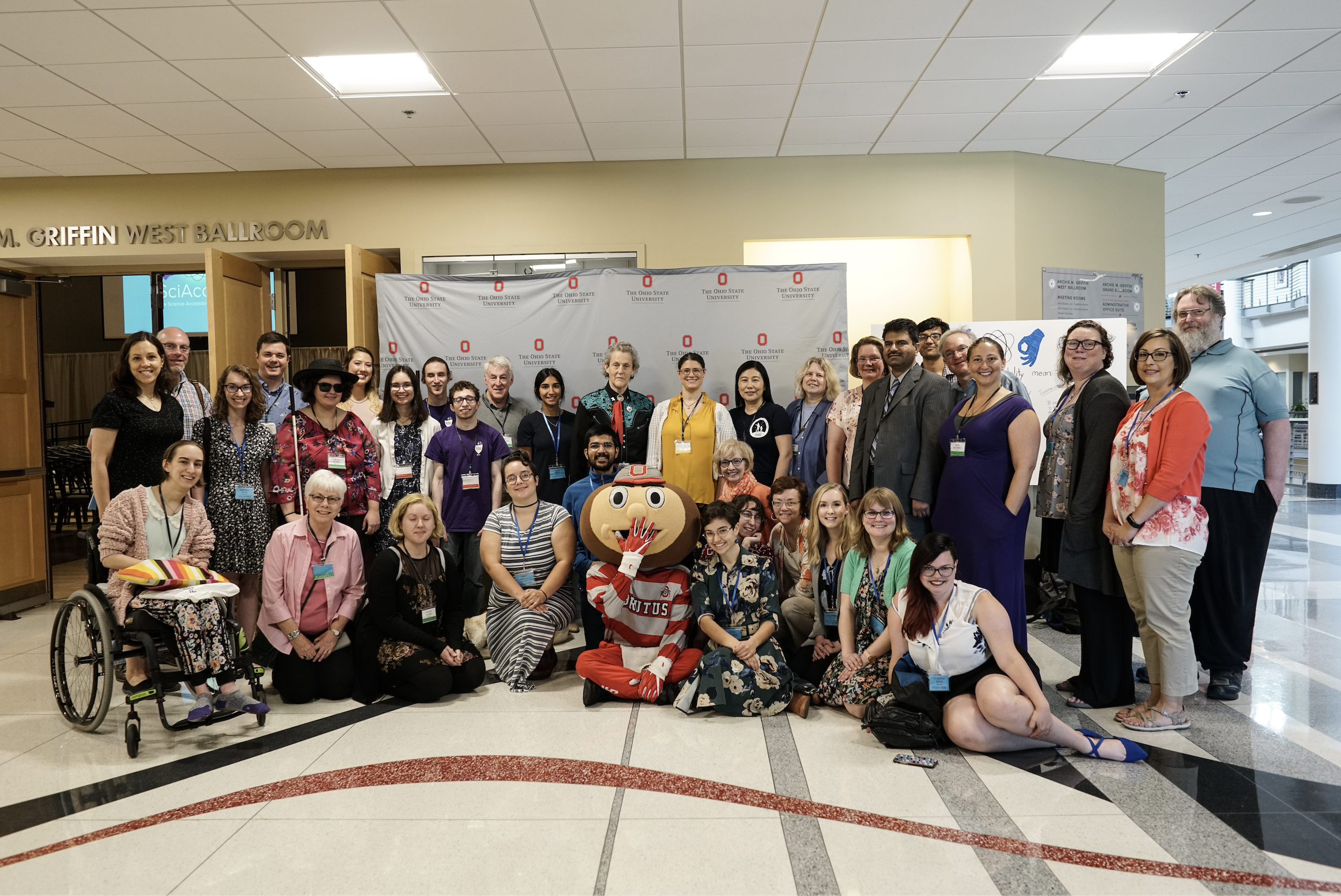 SciAccess 2019 attendees smile for a group photo. In the center of the photo is the Ohio State mascot, Brutus Buckeye.