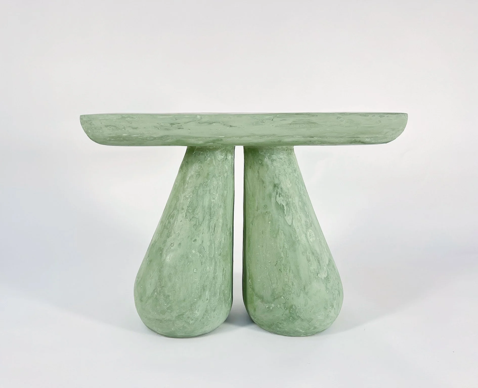 Set of three minimalist green marble vases with wide bases and narrow necks, placed against a plain white background.
