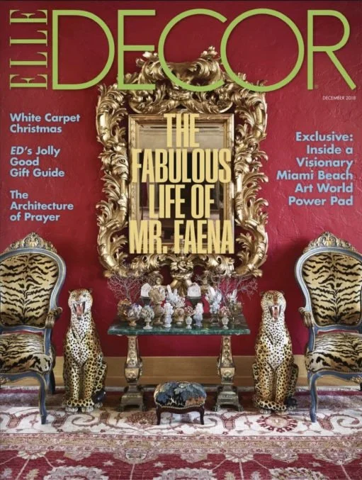 Cover of Elle Decor magazine featuring a luxurious interior decor with ornate gold-framed mirror, two tiger-print velvet chairs, two leopard-shaped sculptures, and a decorative table with floral arrangements, against a red wall. The magazine headline reads "The Fabulous Life of Mr. Faena."