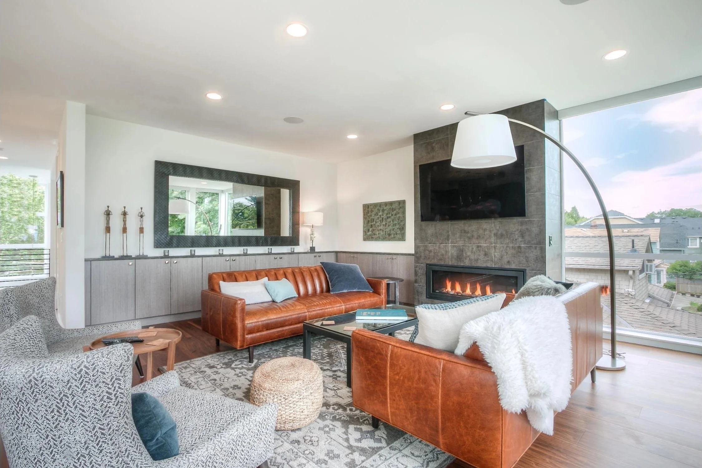 Bright living room with floor to ceiling fireplace and built in cabinets in living room
