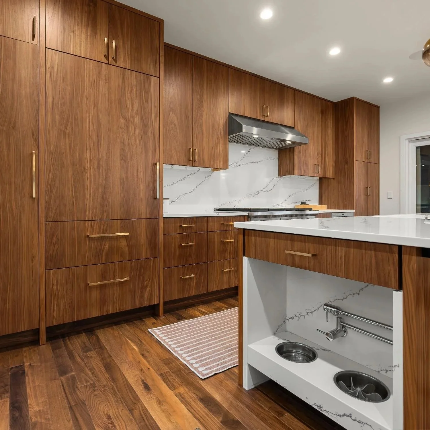 Mid-century kitchen renovation with built in pet feeding area and faucet