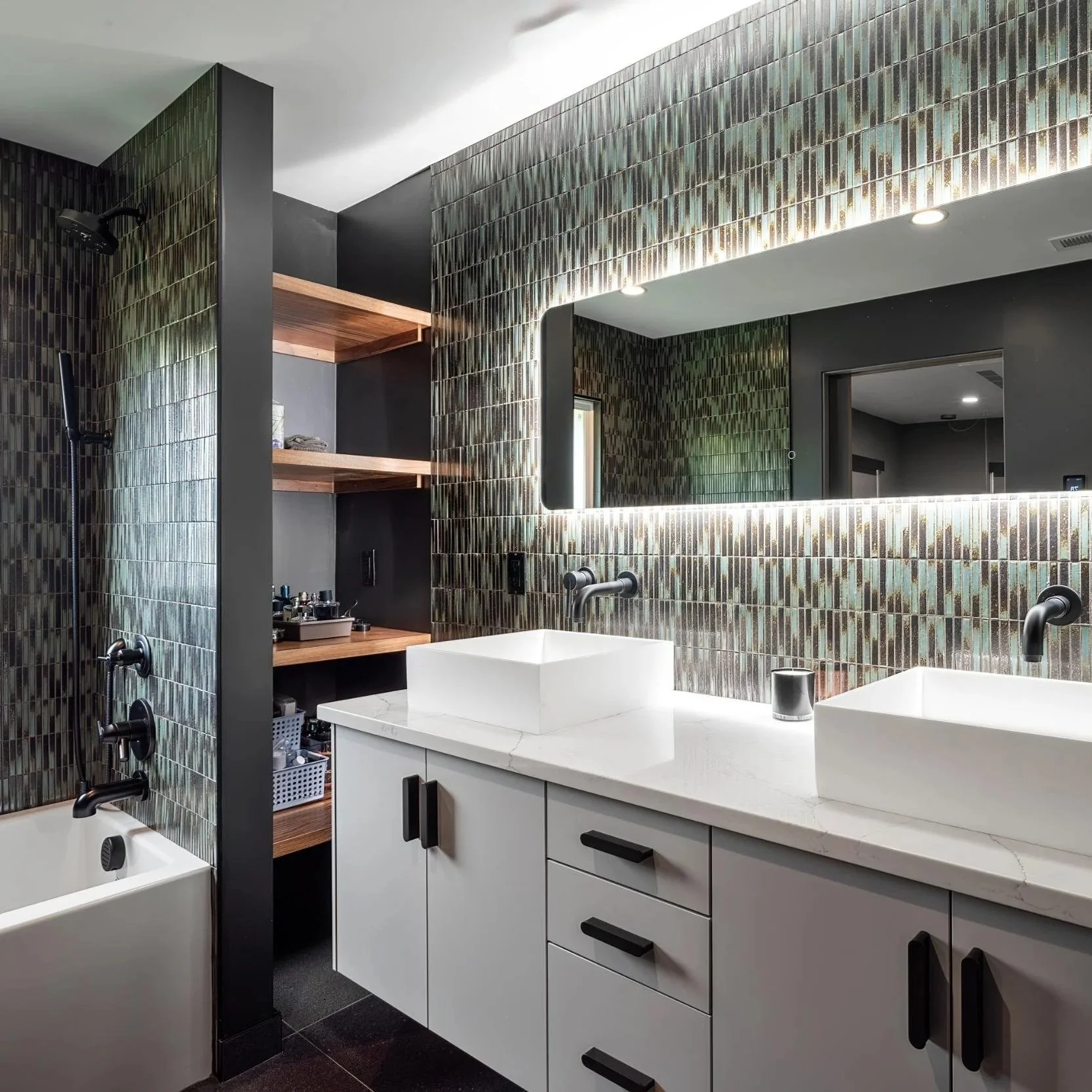 Mid-century renovation of bathroom with vessel sinks, tile and white cabinetry